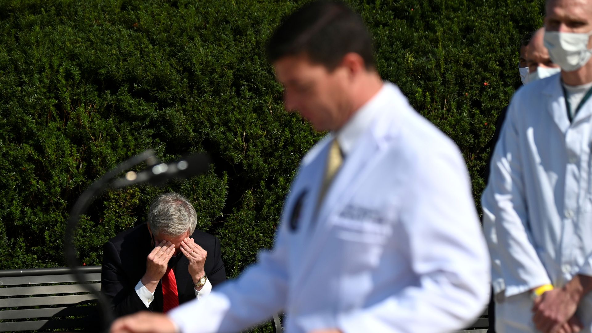 Mark Meadows rubs his forehead while the President's doctor briefs the press