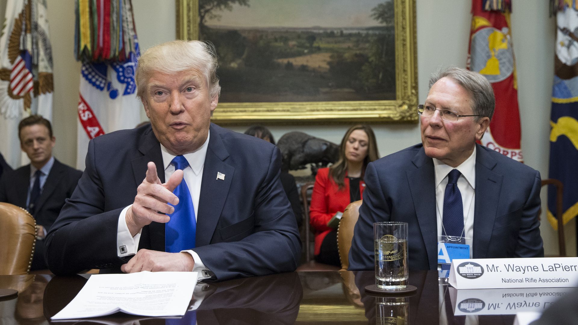 President Donald Trump (L) sits beside Executive Vice President and CEO of the National Rifle Association (NRA) Wayne LaPierre (R)in the Roosevelt Room of the White House on February 1, 2017 