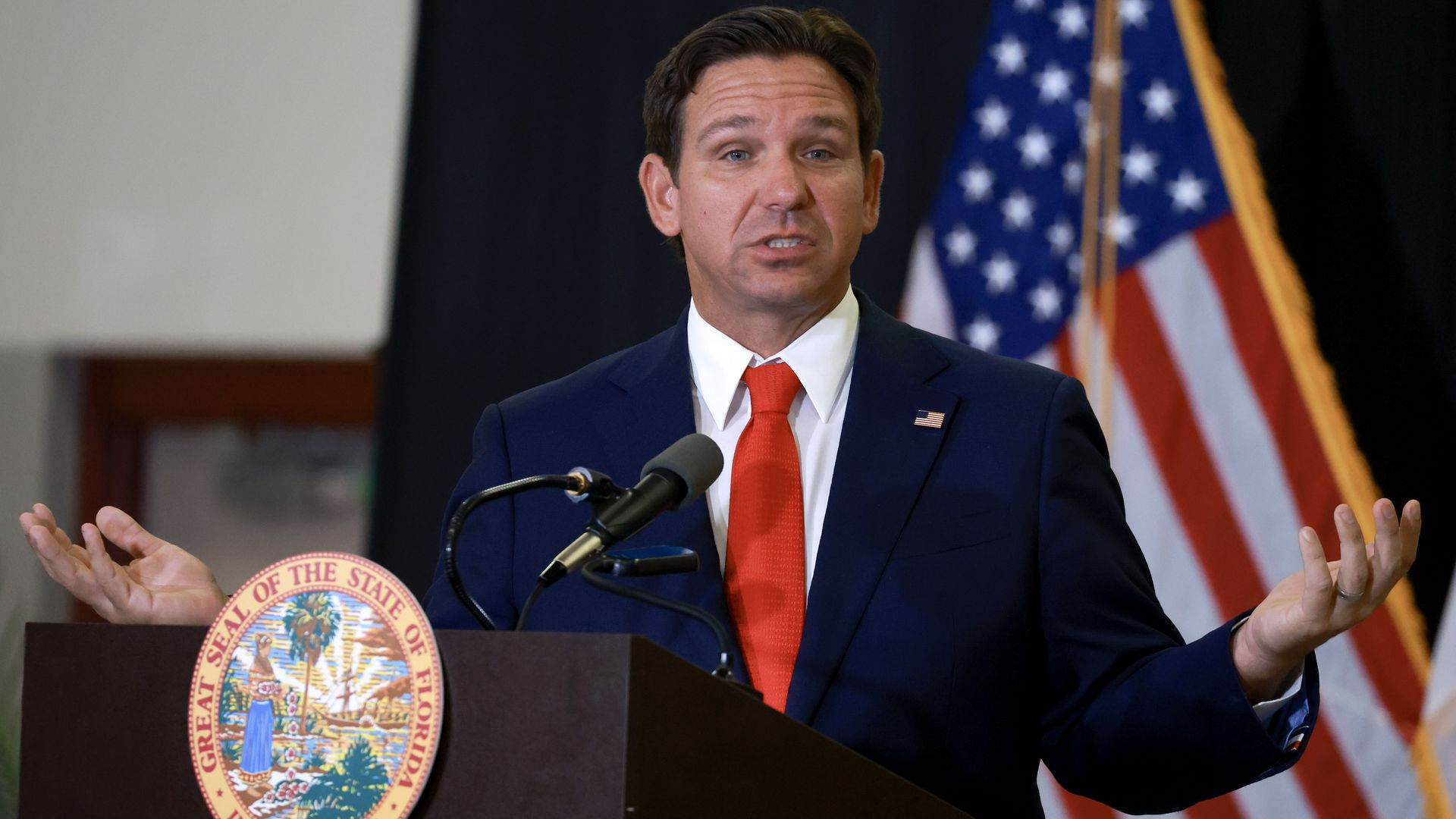 Gov. Ron DeSantis speaks at a podium.