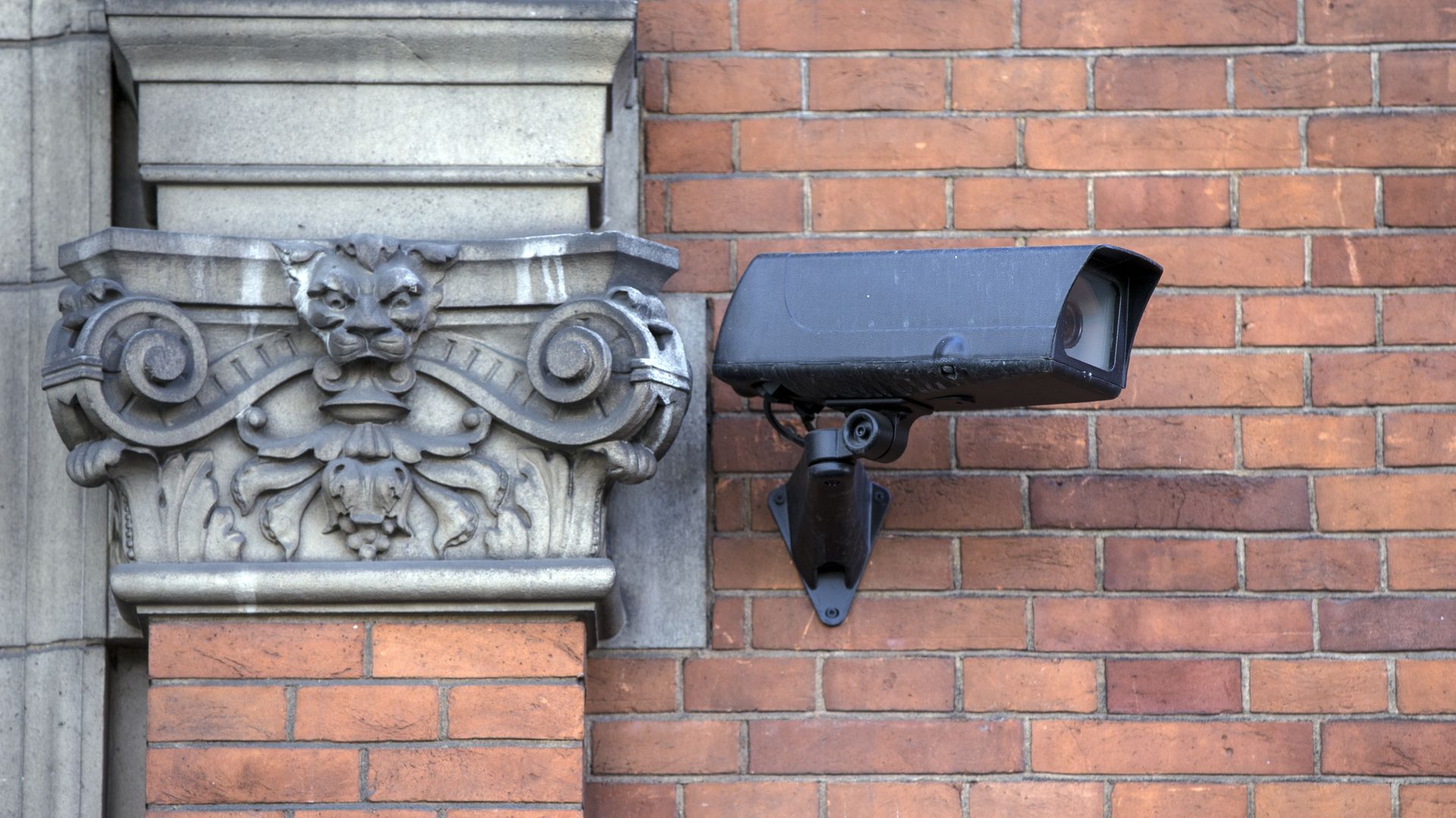 A surveillance camera is mounted on a wall.