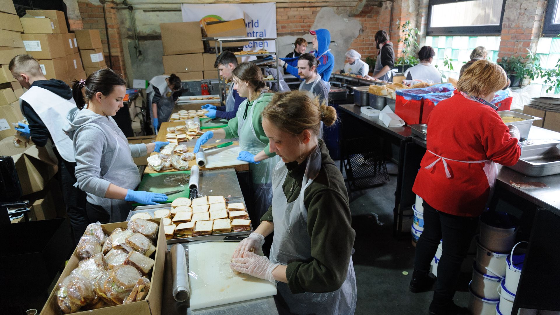 Staff members of a local restaurant together with the organization World Central Kitchen prepare sandwiches
