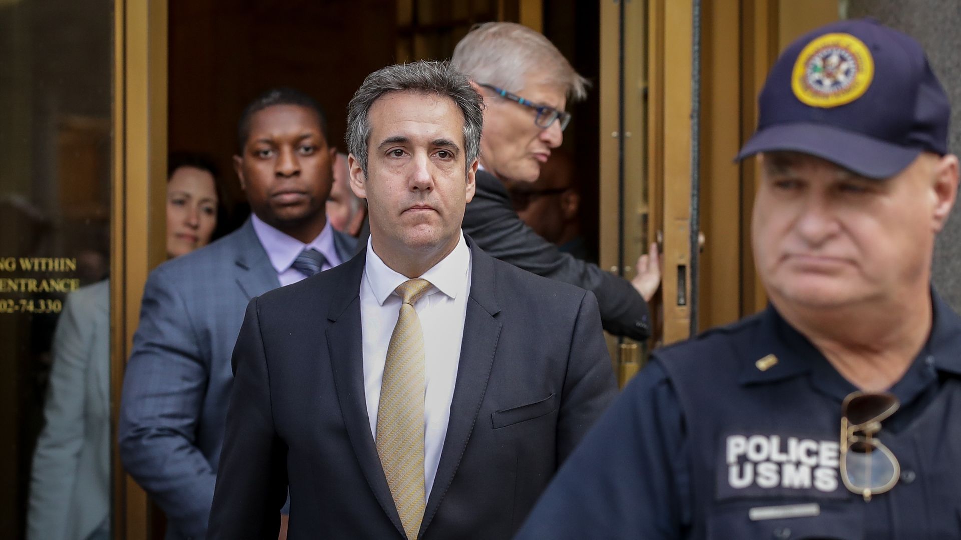 Michael Cohen leaves a courthouse in New York