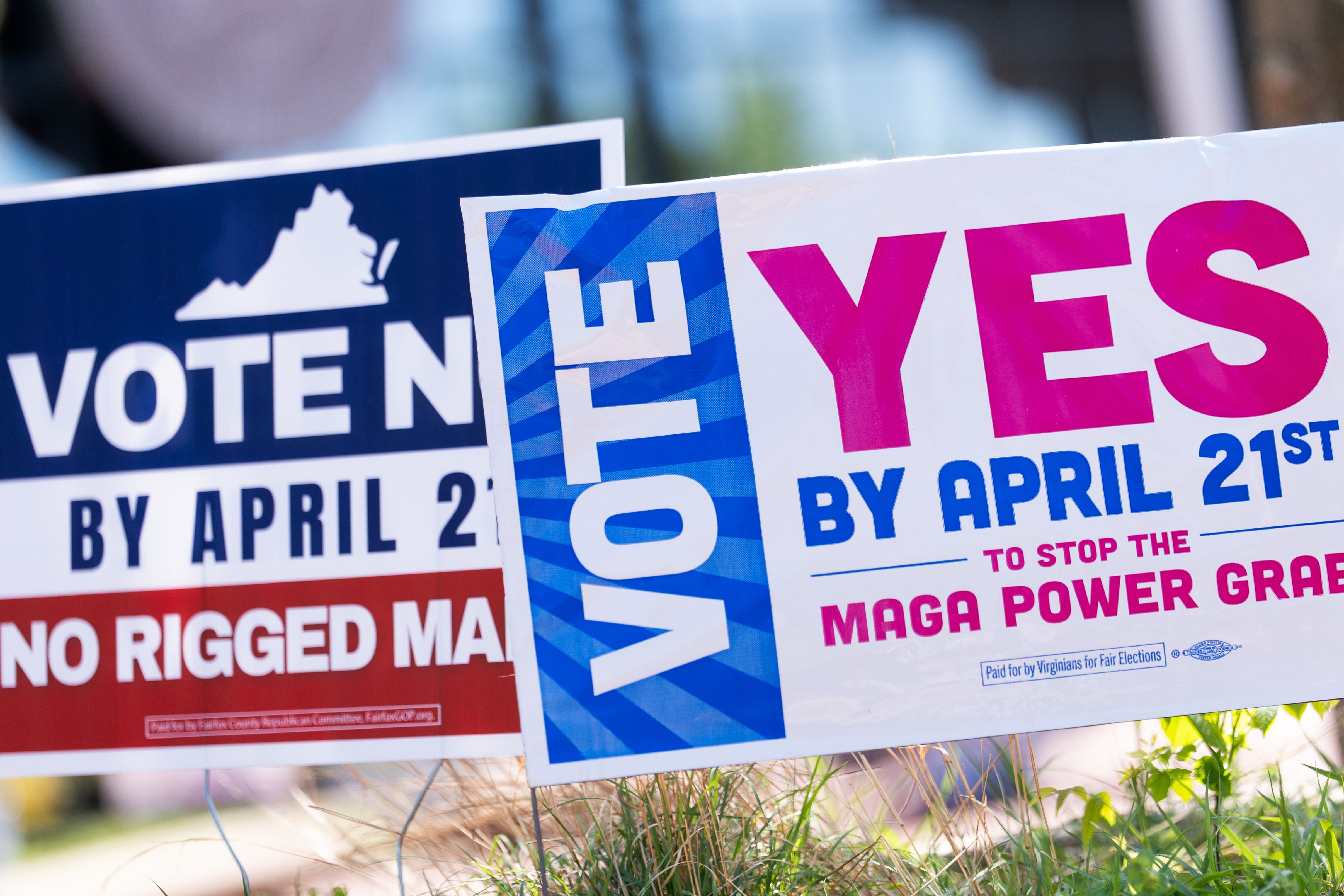 Signs outside the Fairfax County Government Center during yesterday's voting on a Virginia redistricting referendum.