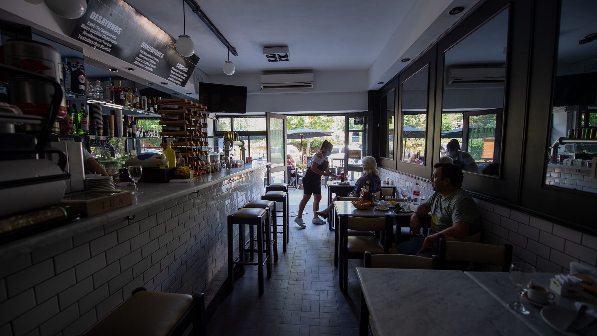 People sit in a cafe in Buenos Aires at over 40 degrees where the electricity has failed.