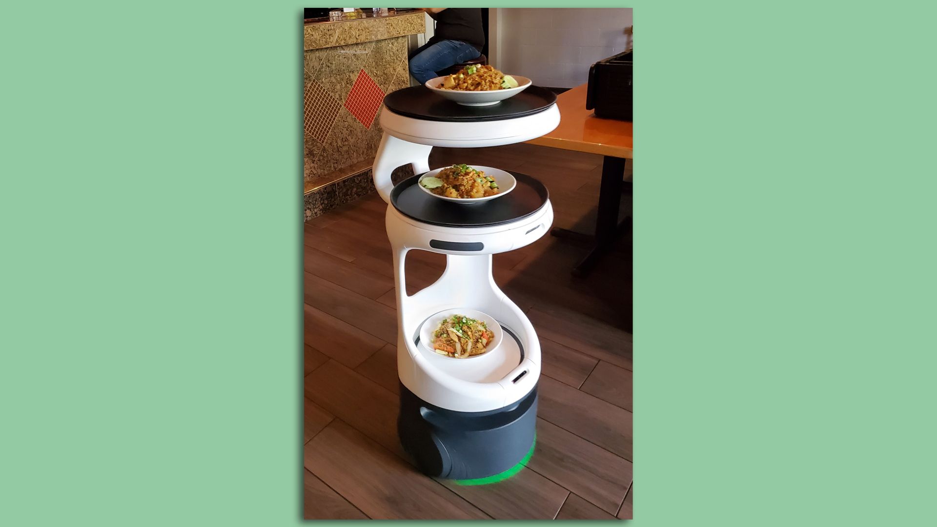 A robot that serves food from three stacked bowls