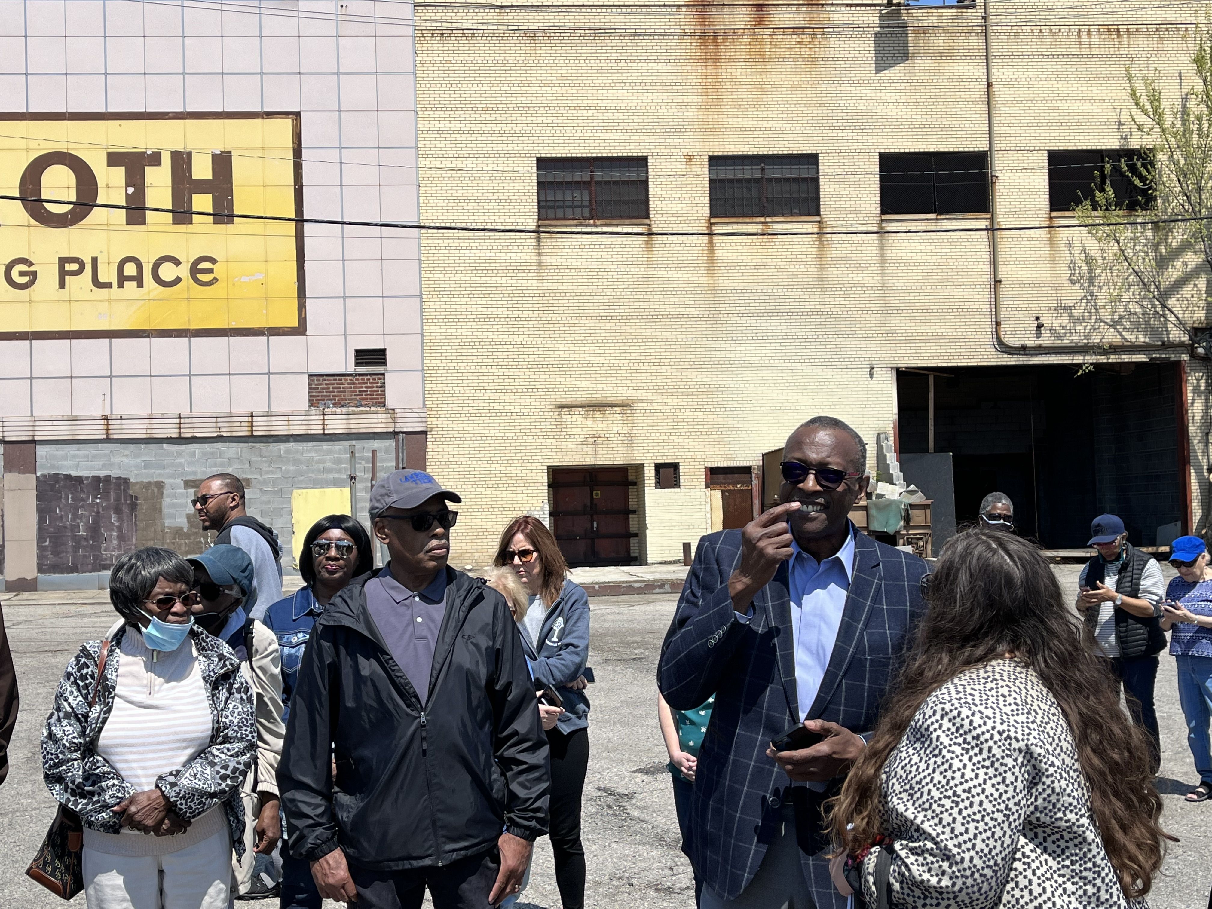 Herb Strather, in a blue blazer, talks to residents about his efforts to redevelop the Mammoth building.