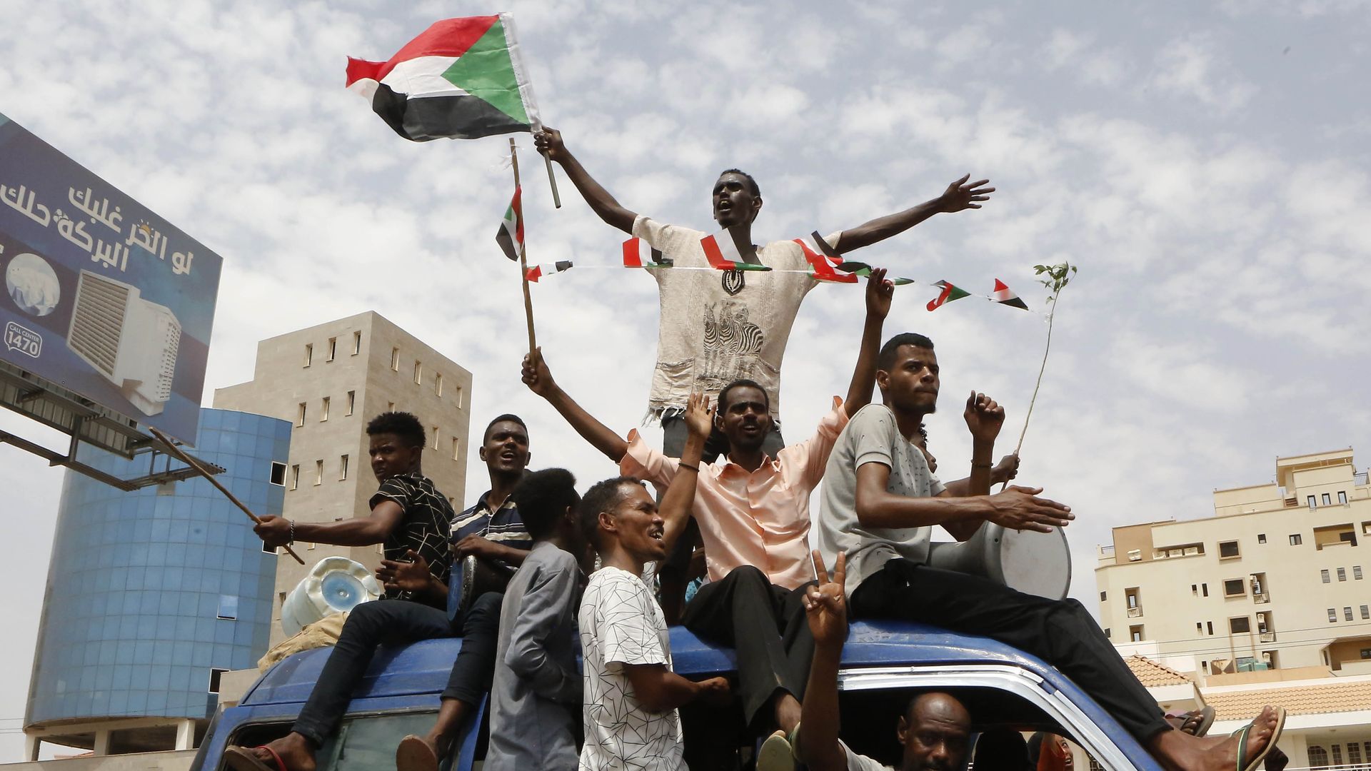 Sudanese people celebrate after civilian and military leaders reached an agreement