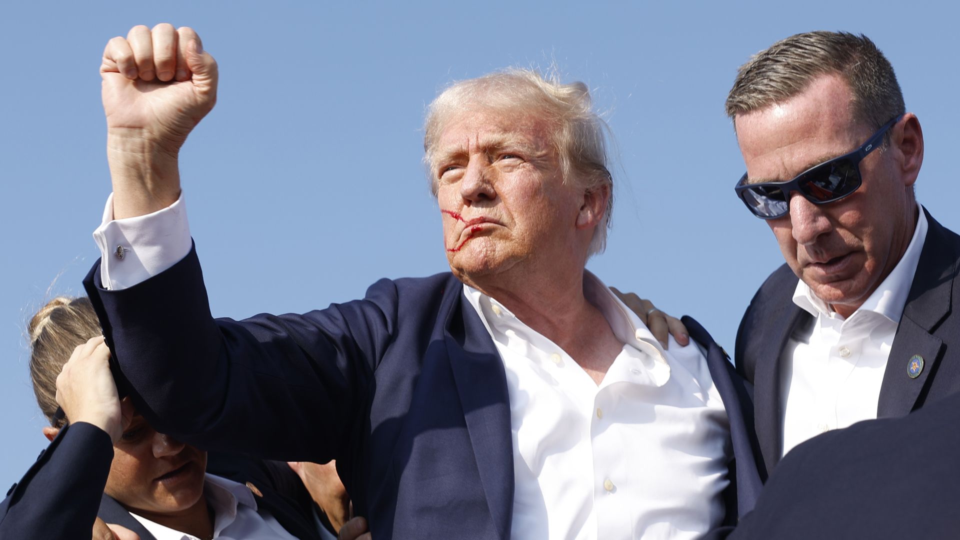  Republican presidential candidate former President Donald Trump is rushed offstage during a rally on July 13, 2024 in Butler, Pennsylvania.
