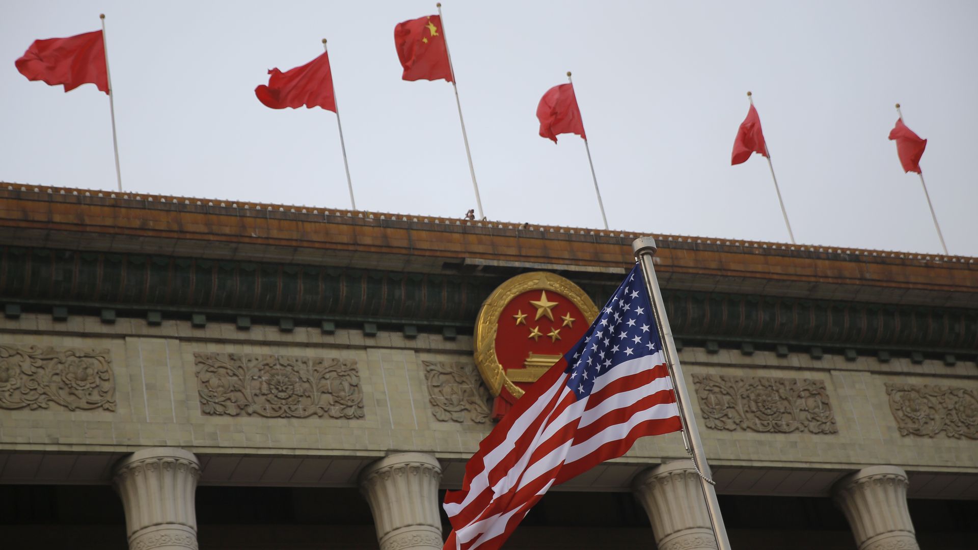 American and Chinese flags fly