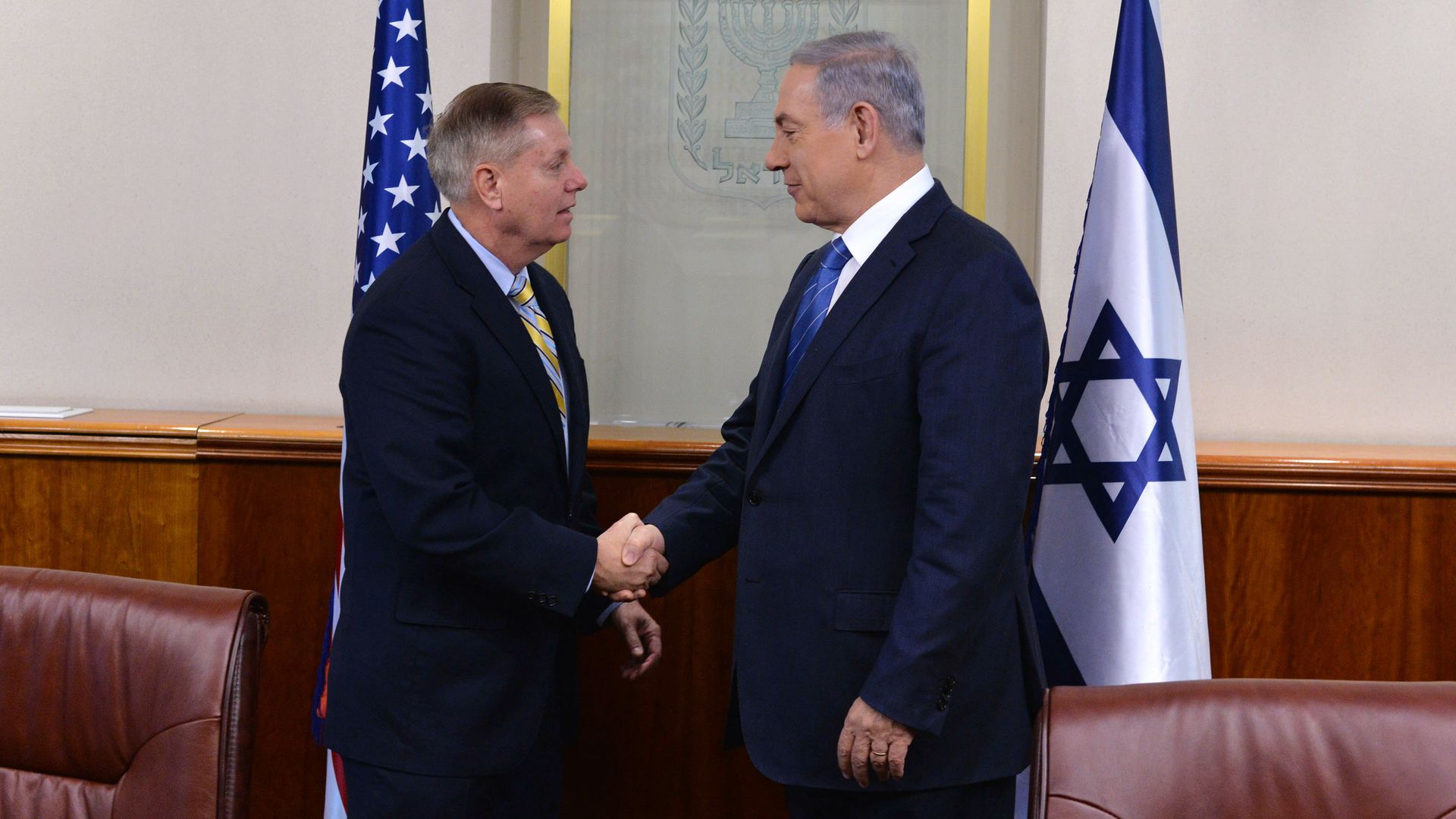 n this handout image provided by the Government Press Office, Israel Prime minister Benjamin Netanyahu (R) shakes hands with U.S. Senator Lindsey Graham (R-SC)