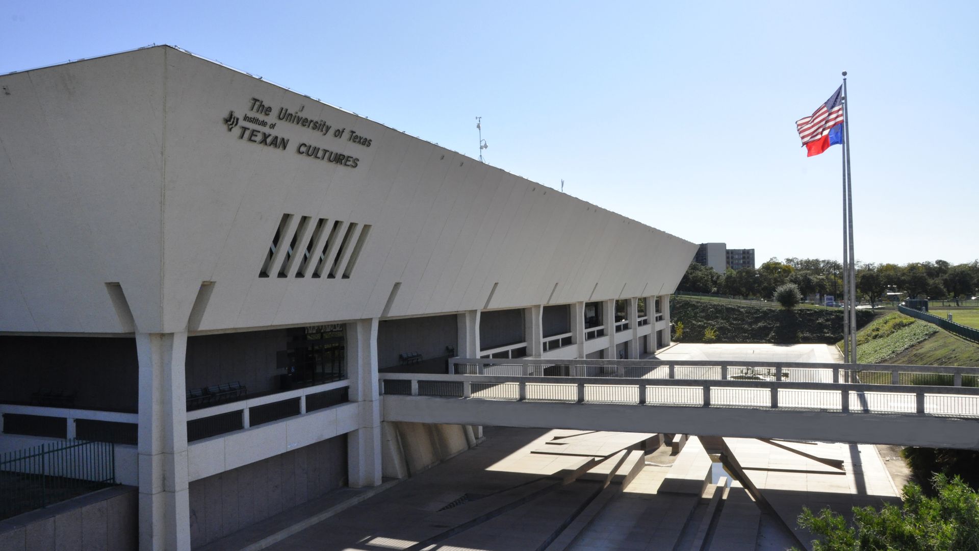 A rectangular, beige building with the words "The University of Texas Institute of Texan Cultures" on it. 