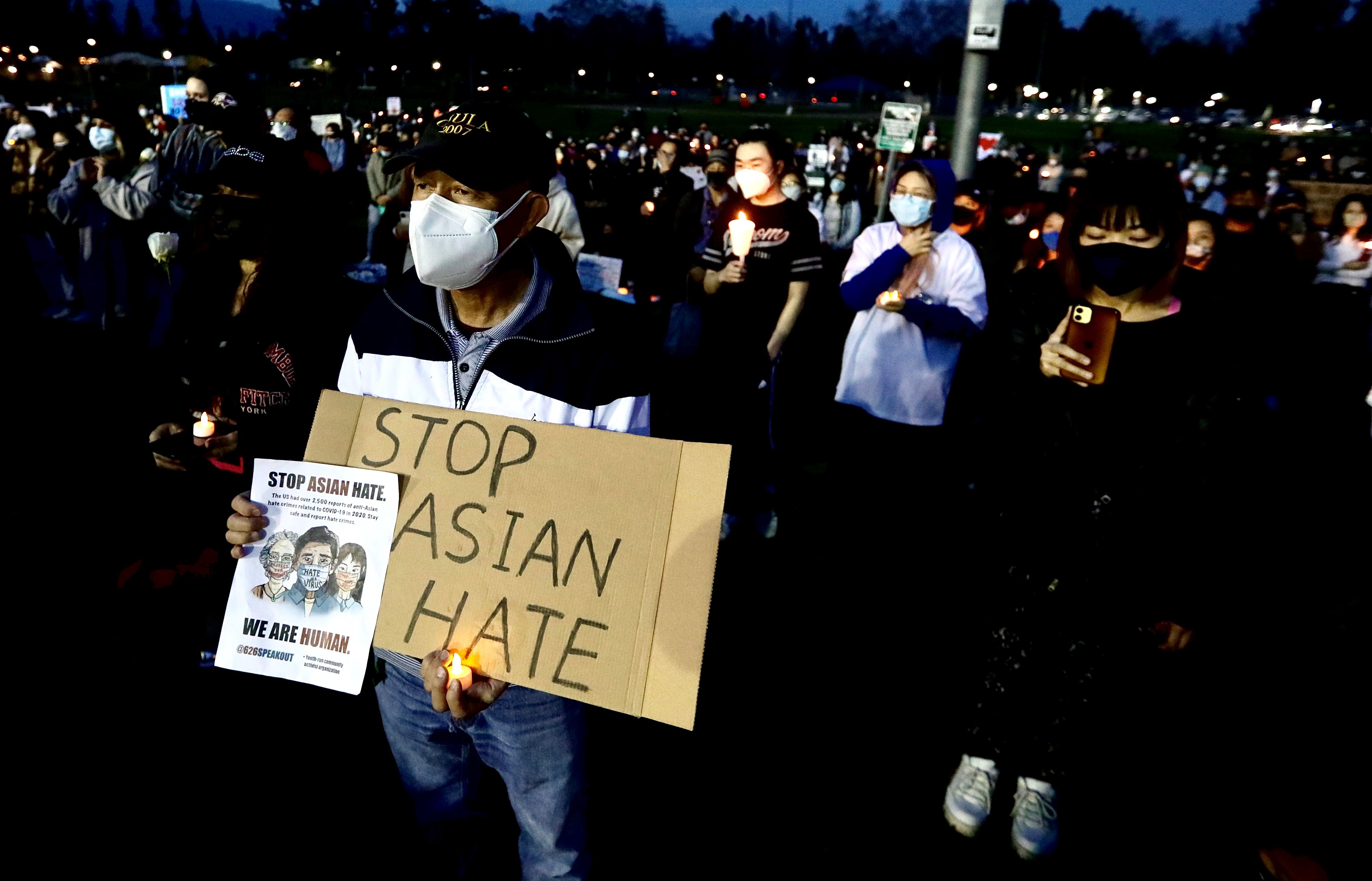 People attend a "Stop Asian Hate" candlelight vigil in a city park of Alhambra, Los Angeles County, California
