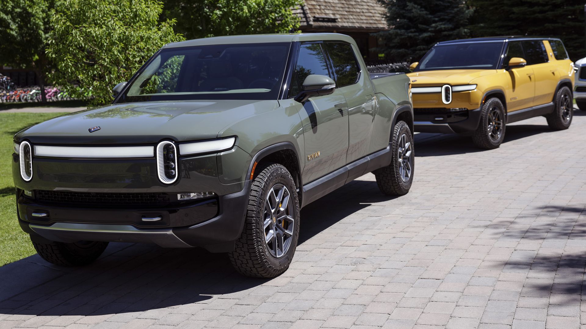  A Rivian R1T Truck and R1S SUV is parked outside the Allen & Company Sun Valley Conference on July 08, 2022 in Sun Valley, Idaho.