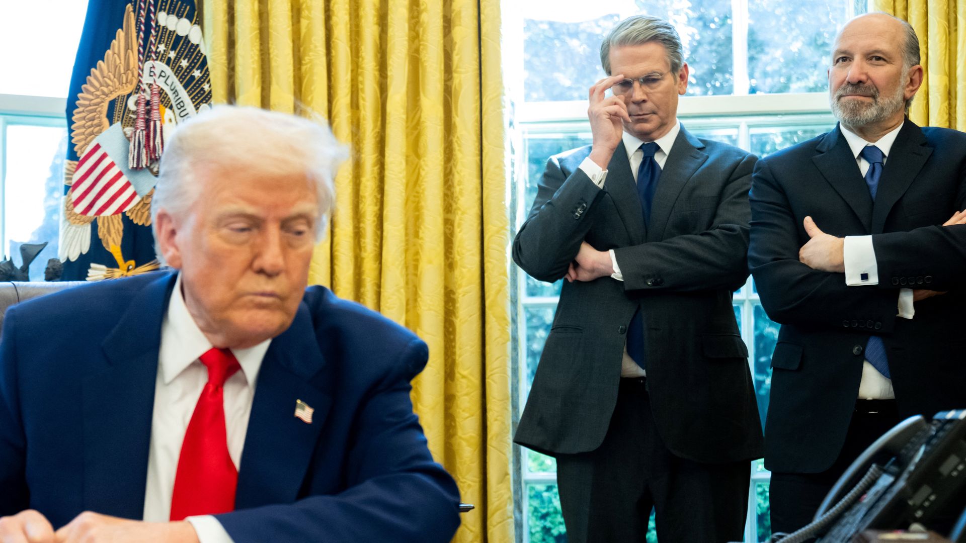 US Treasury Secretary Scott Bessent (2nd R) and Commerce Secretary Howard Lutnick look on as President Donald Trump speaks after signing an executive order as in the Oval Office of the White House on April 9, 2025 in Washington, DC. (Photo by SAUL LOEB / AFP) (Photo by SAUL LOEB/AFP via Getty Images