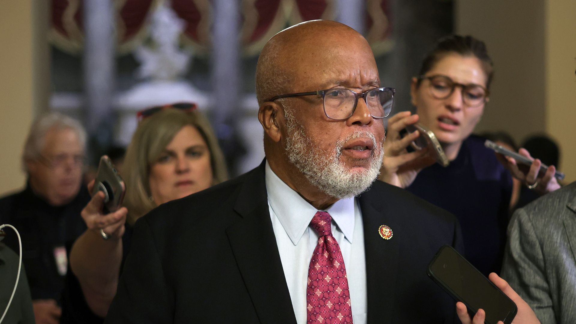 Rep. Bennie Thompson, wearing a white shirt, red tie and dark gray suit, speaks to reporters outside Speaker Nancy Pelosi's office at the Capitol.