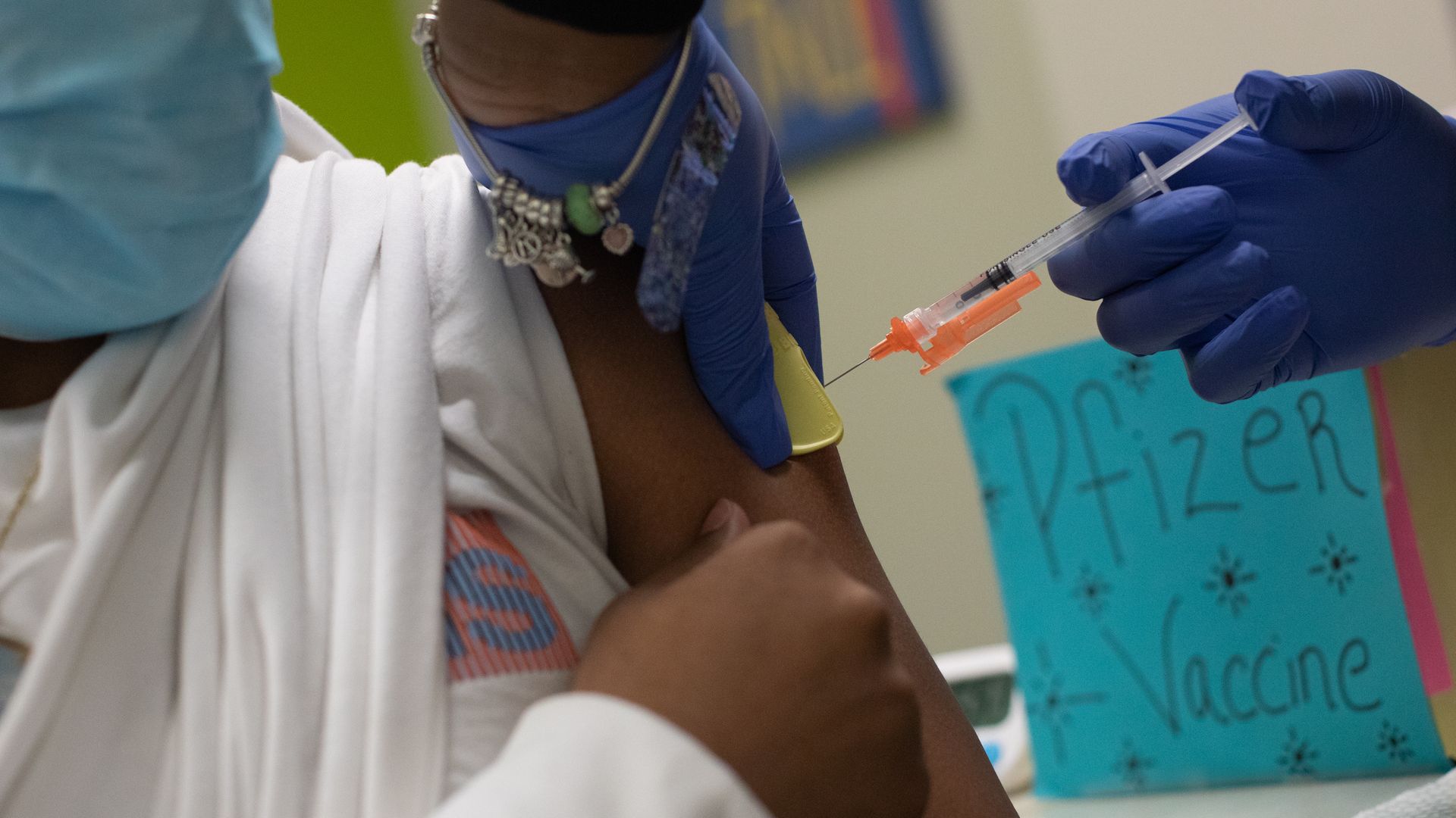 A healthcare worker administers a dose of a Pfizer-BioNTech Covid-19 vaccine to a child at a pediatrician's office in Bingham Farms, Michigan, U.S