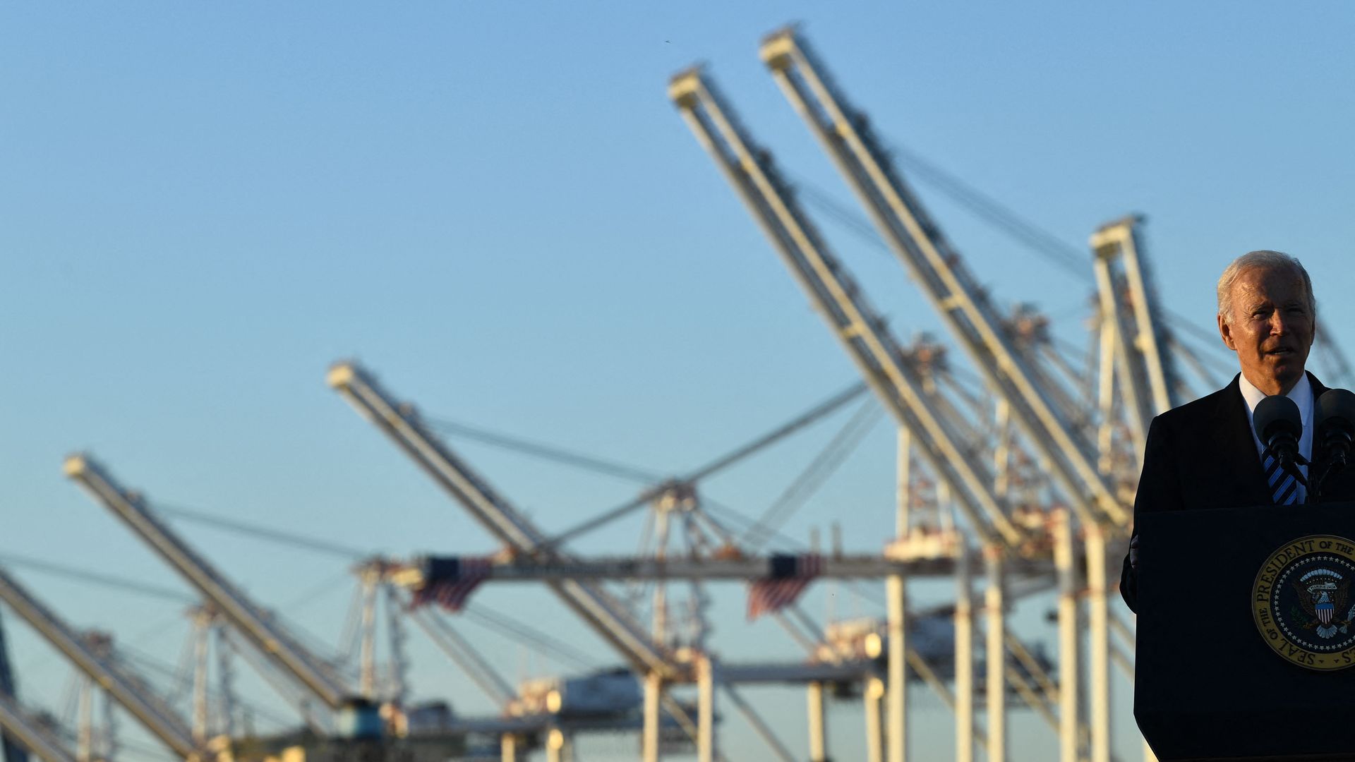 President Biden is seen speaking before cranes at the Port of Baltimore.
