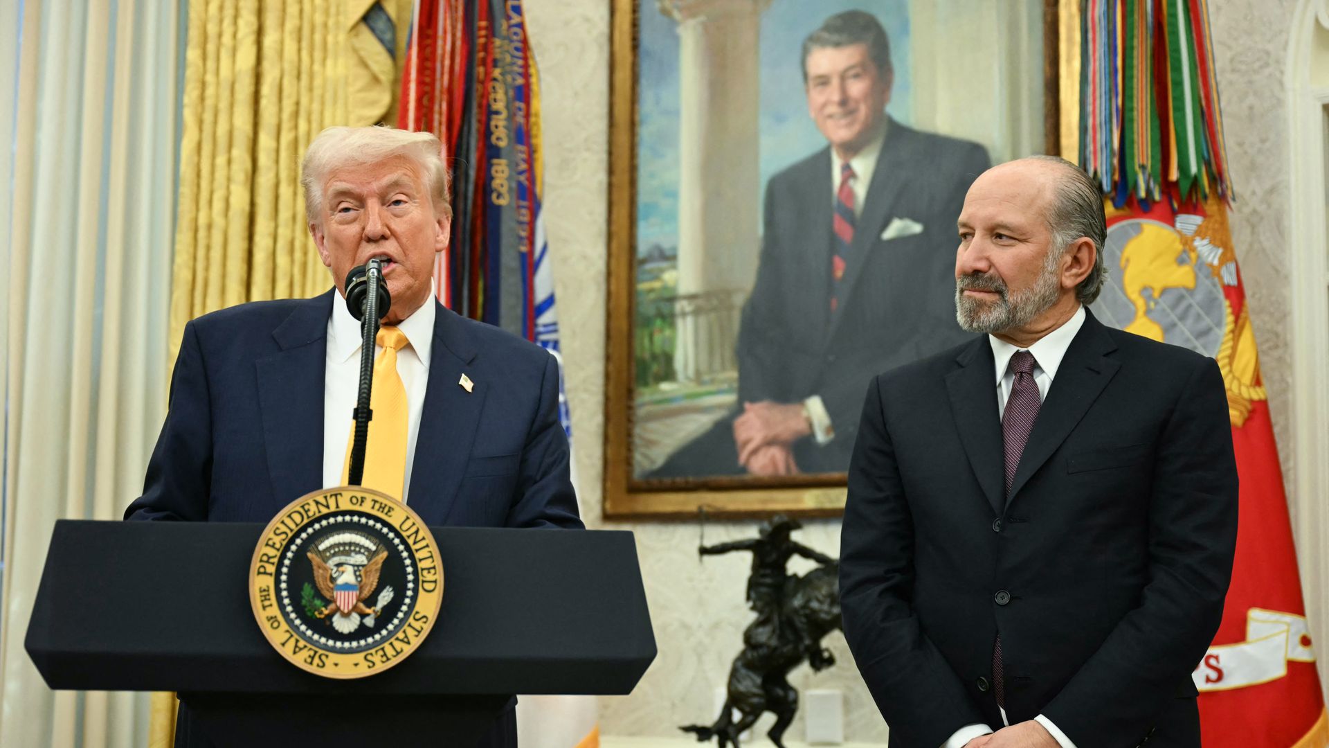  President Trump speaks during a ceremonial swearing-in for US Secretary of Commerce Howard Lutnick (R) in the Oval Office of the White House in Washington, DC, on February 21, 2025. 