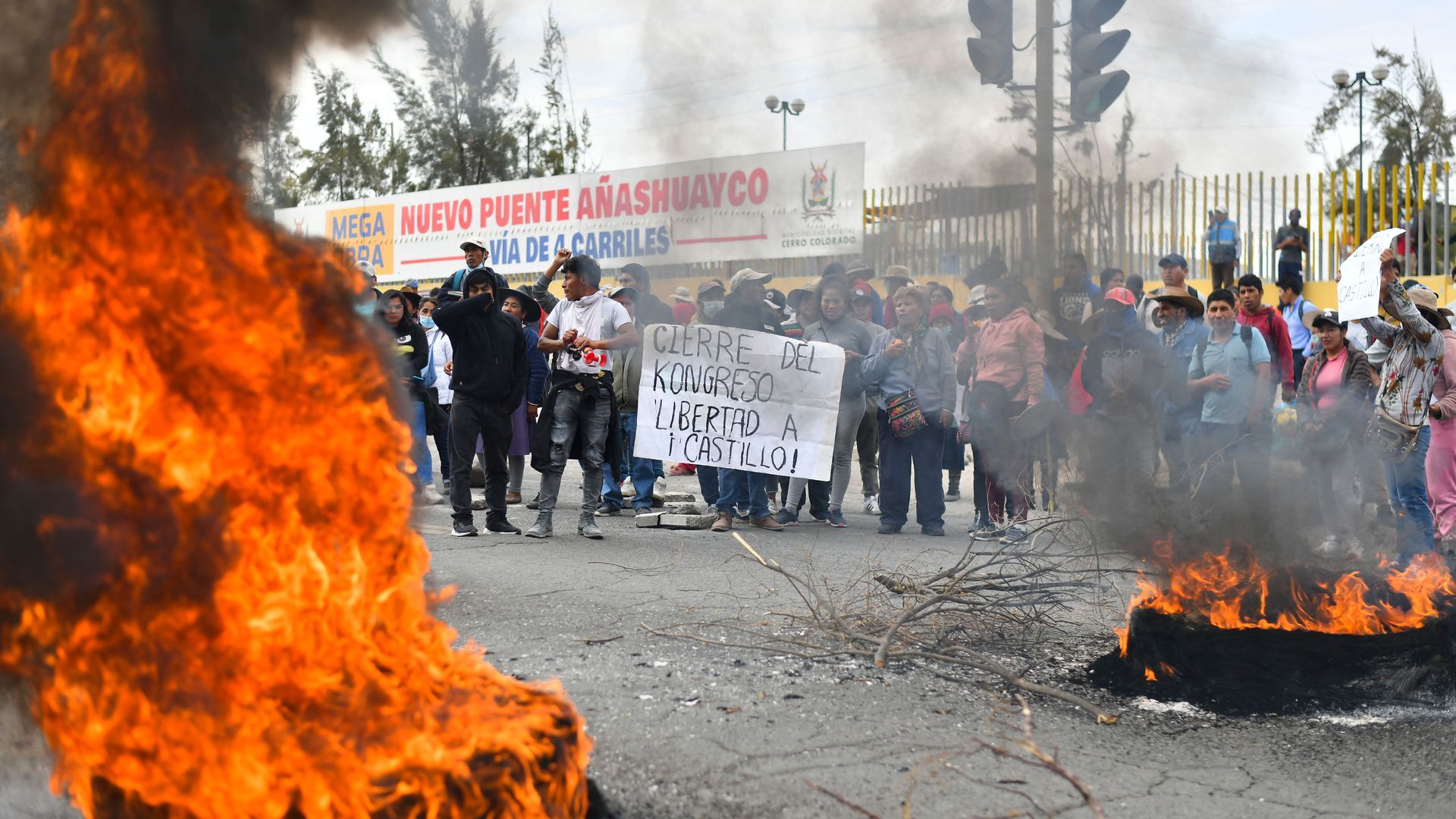 Supporters of Pedro Castillo hold a sign criticizing Congress in Arequipa, Peru, Dec. 12. Photo: Diego Ramos/AFP via Getty Images