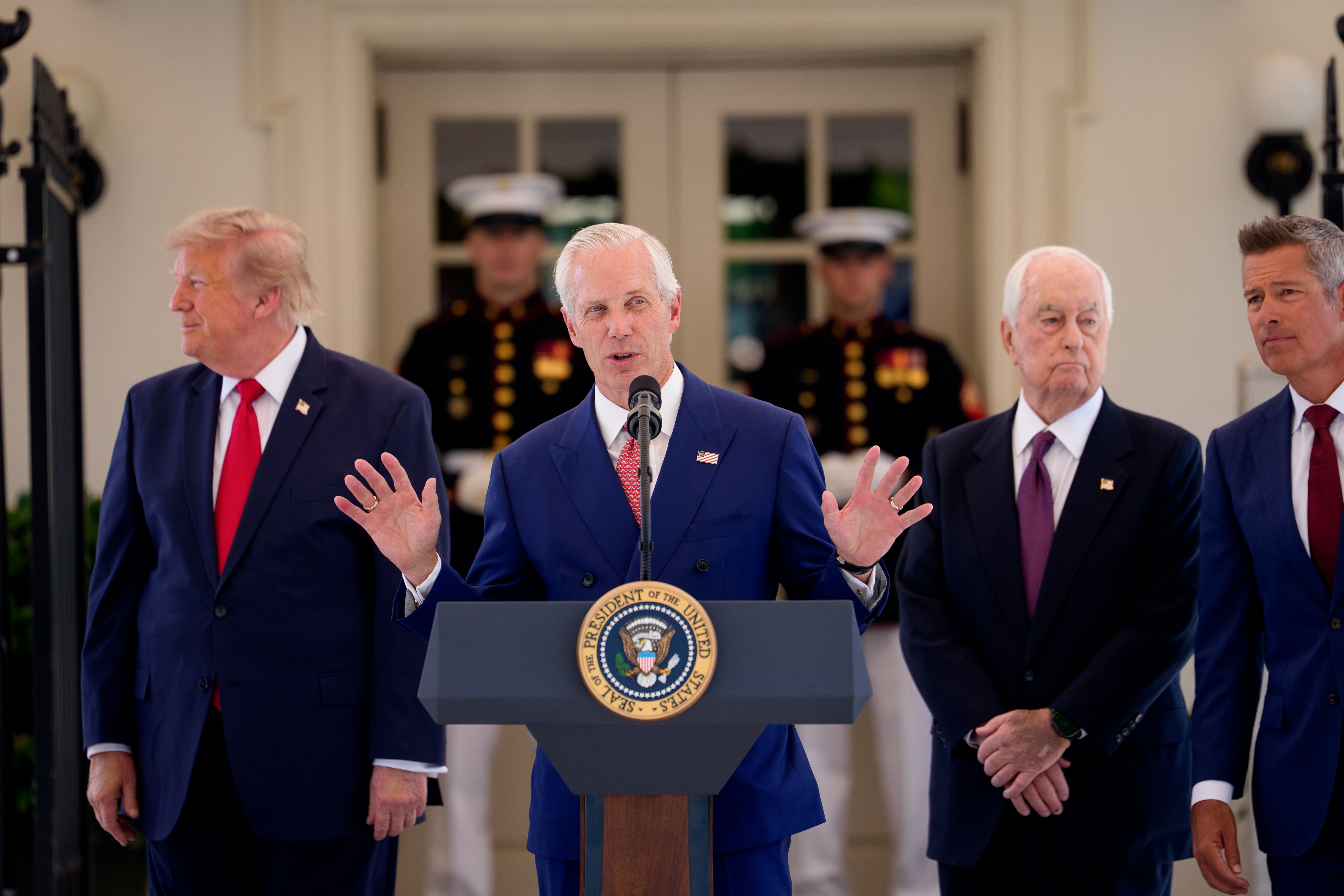 Bud Denker speaks at an event outside the West Wing with President Trump last month.