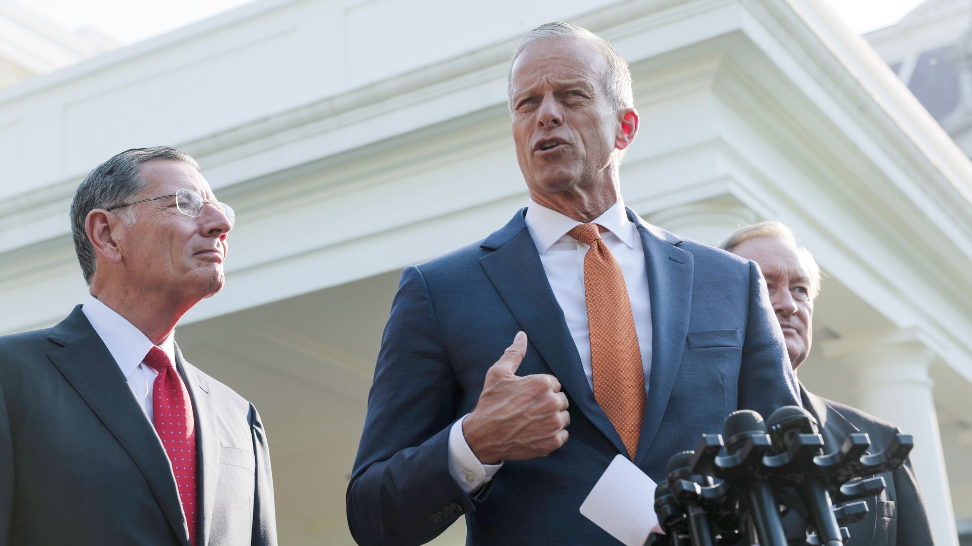 Senate Majority Leader Sen. John Thune (R-SD) (C) speak alongside Sen. John Barrasso (R-WY) (L) outside of the West Wing of the White House