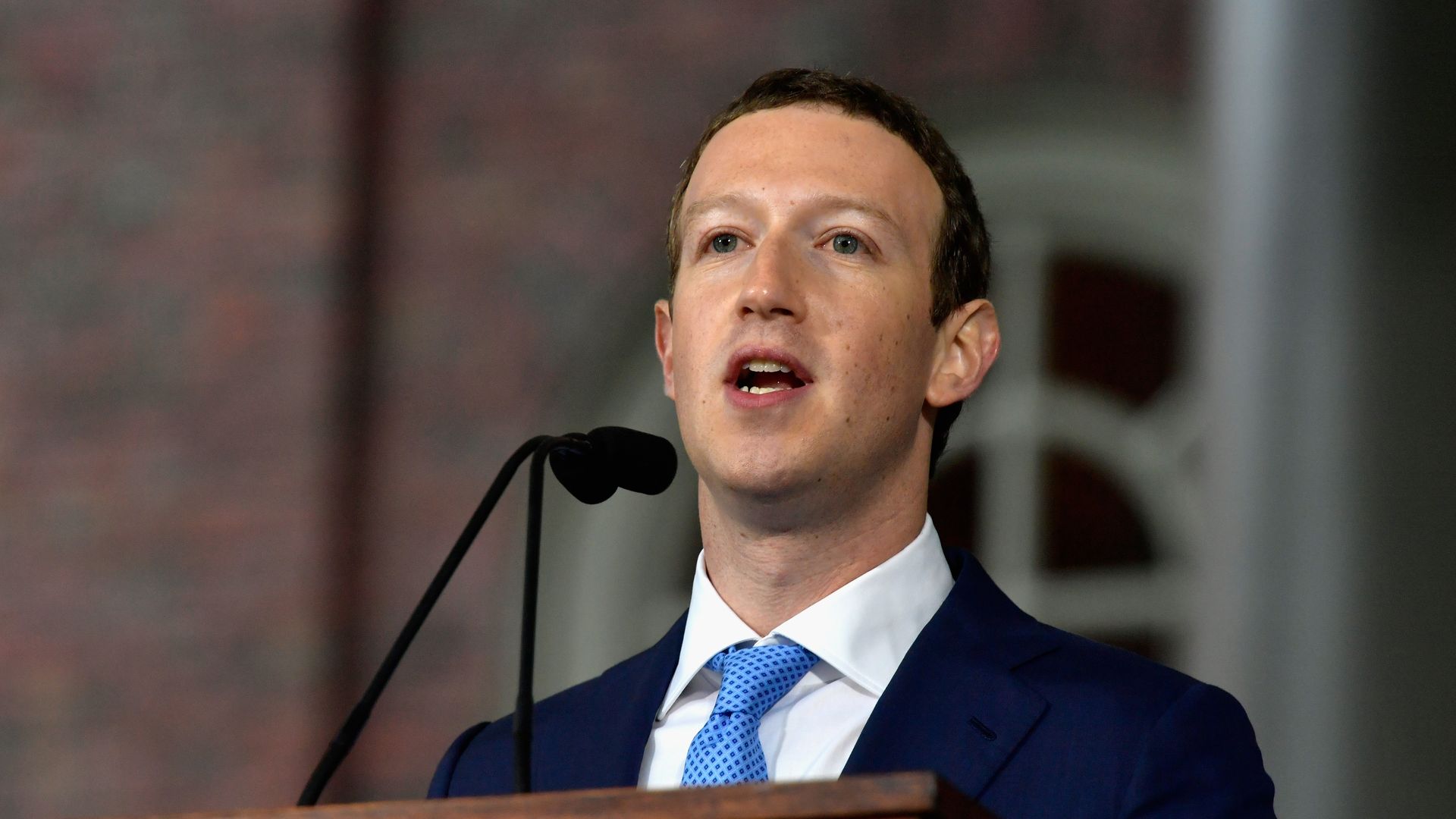 Facebook CEO Mark Zuckerberg speaks from behind a podium