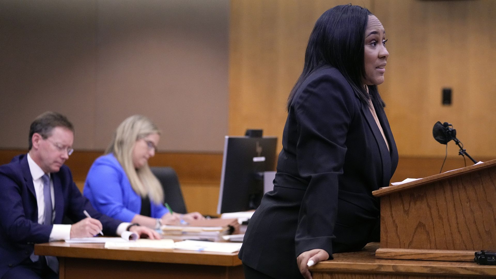 Fani Willis argues at a podium in a courtroom
