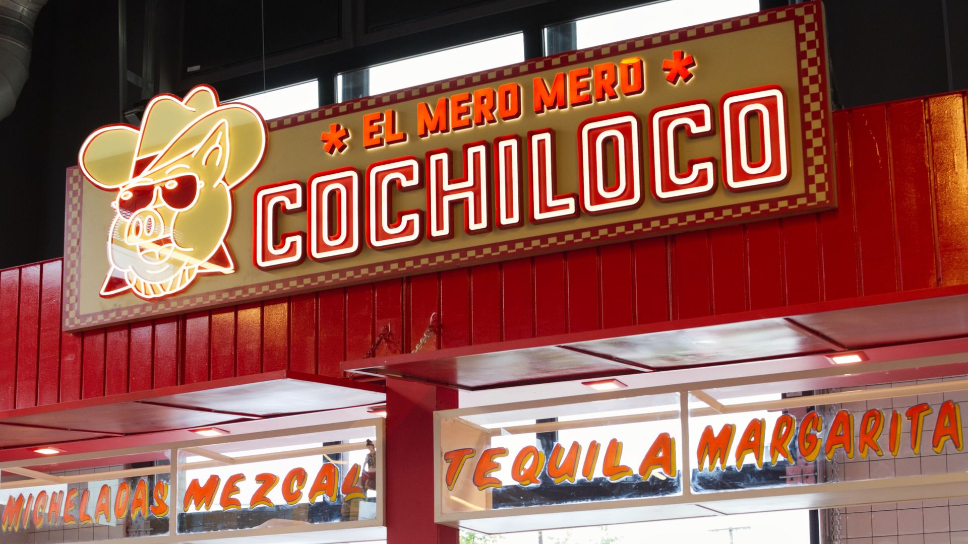 A cool looking taco counter that is red 