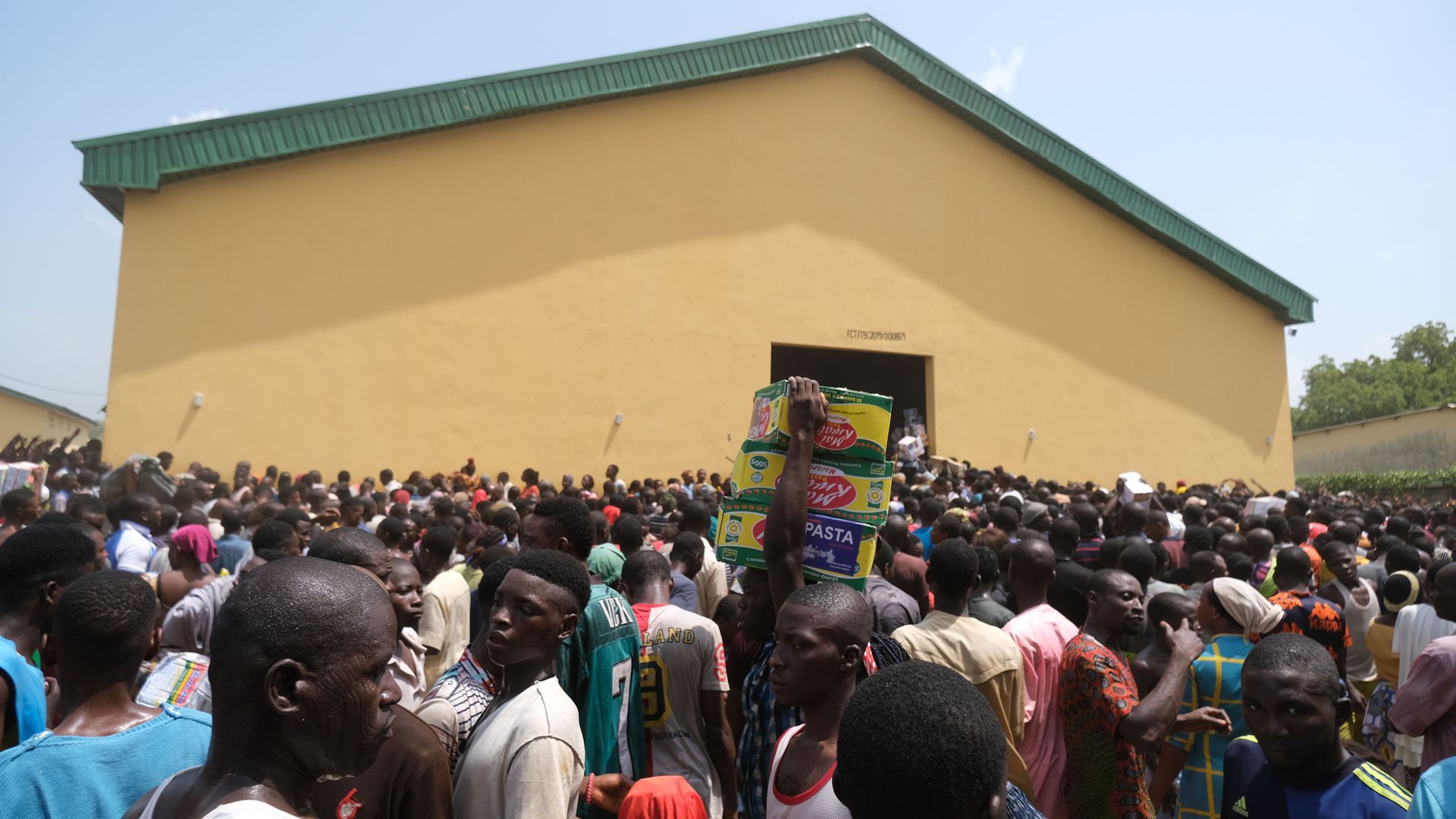 Protesters crowd a food distribution center in Abuja, Nigeria, in October 2020.