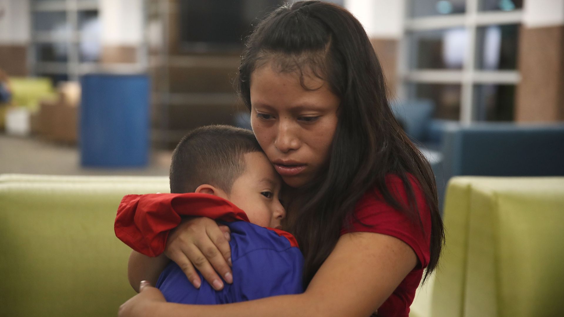 A woman, identified only as Maria, is reunited with her son, 4, at the El Paso International Airport.