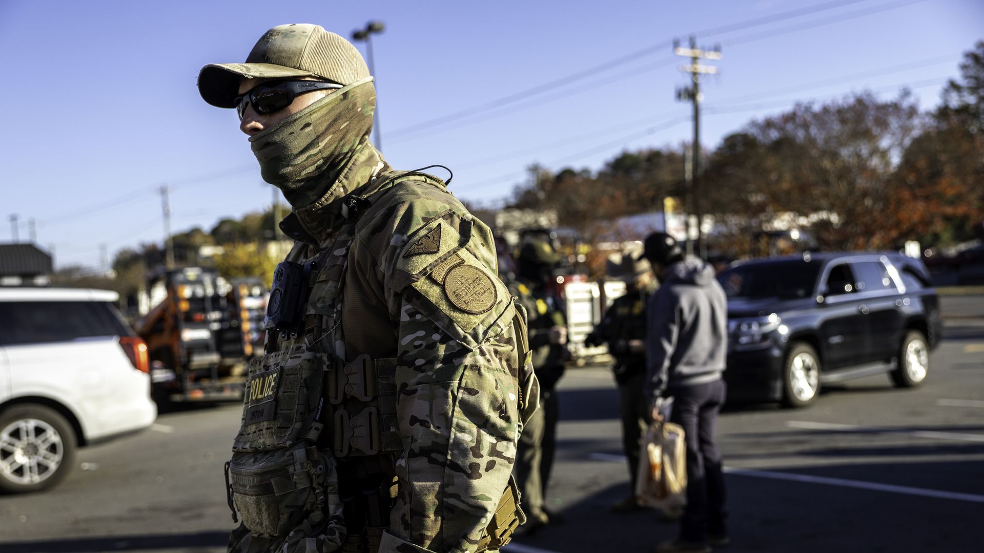 U.S. Border Patrol agents stand outside a Home Depot in the parking lot