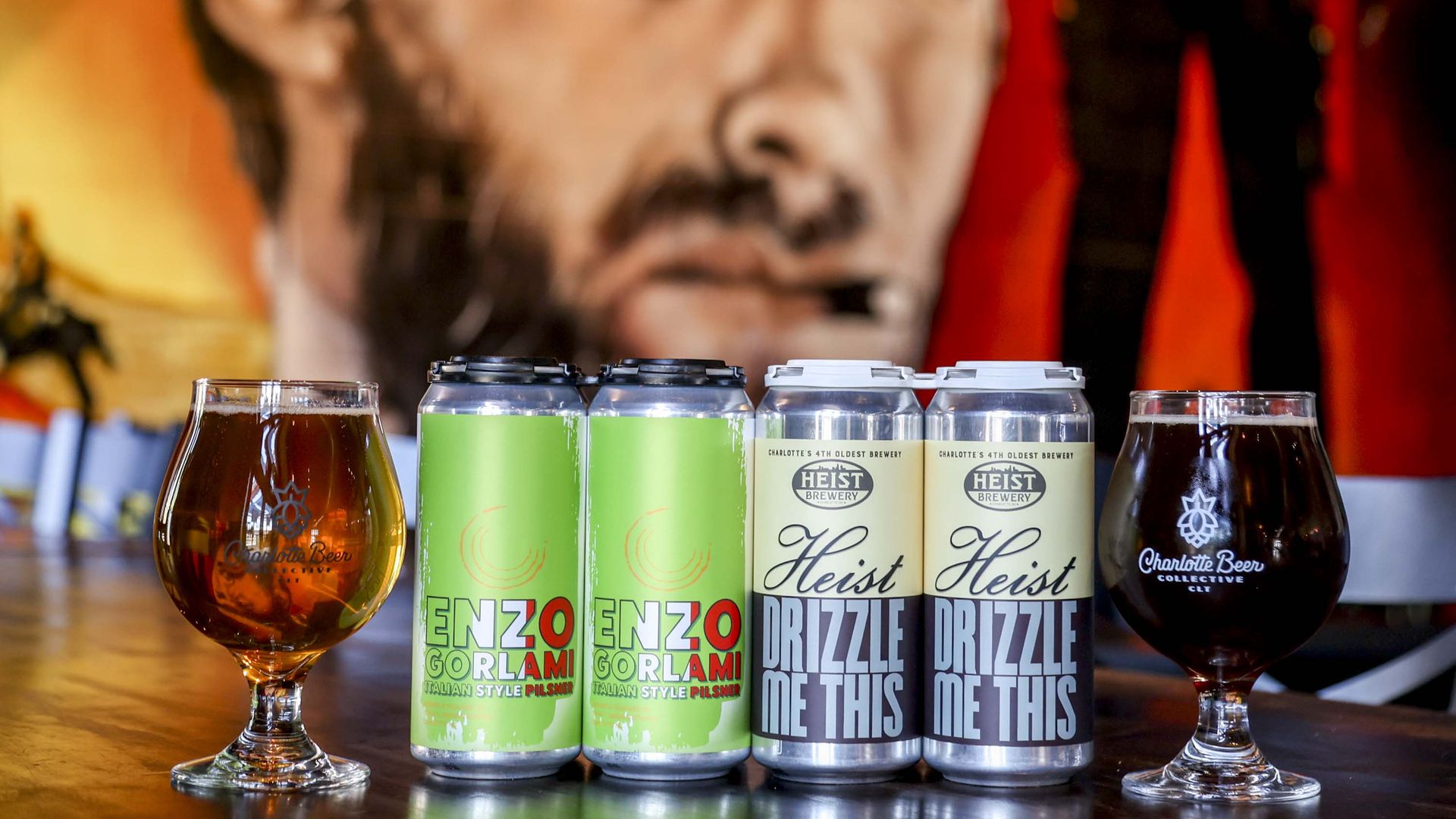 cans of beer next to glasses full of beer