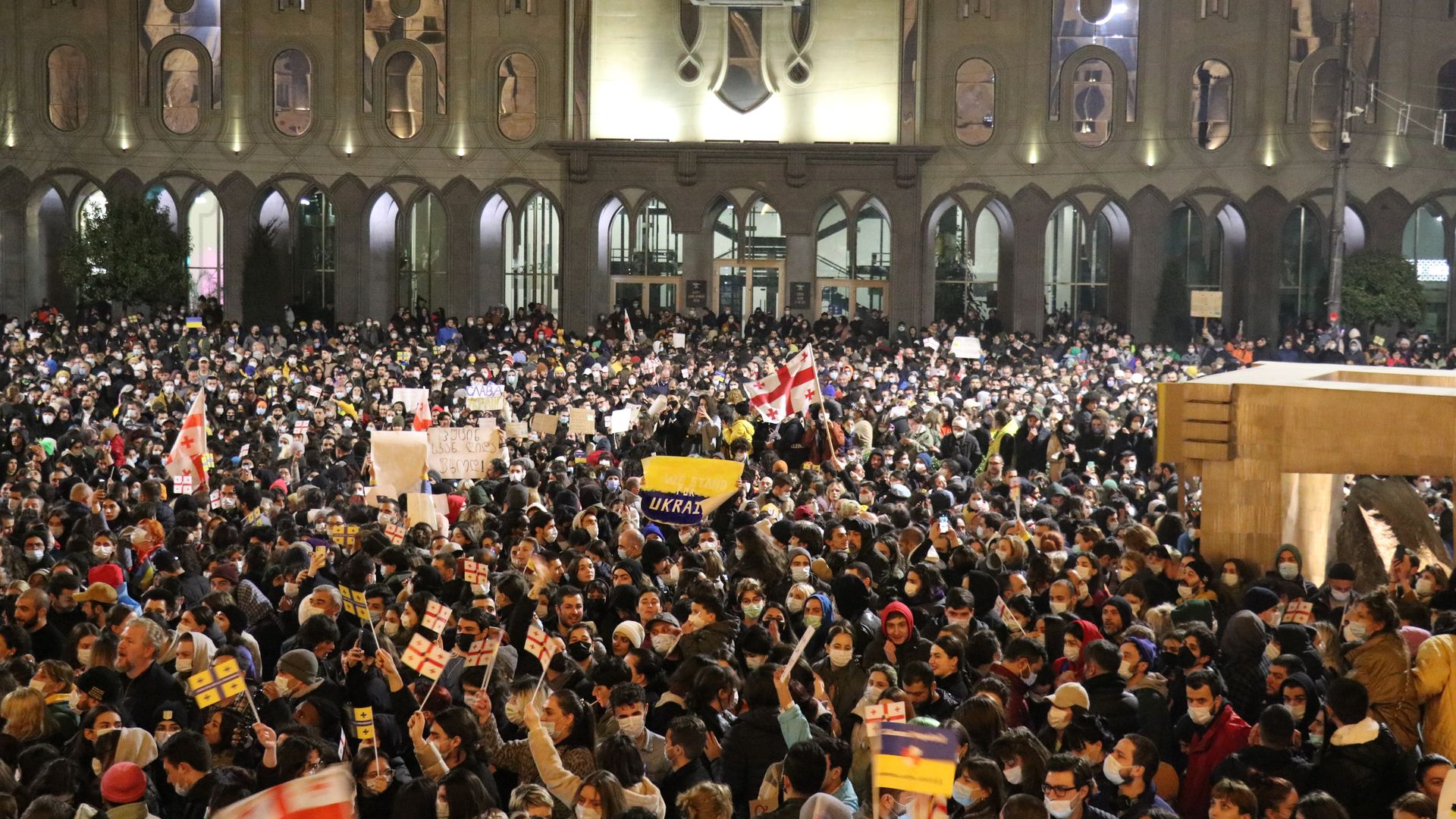 Photo of a large crowd of people packed into an outdoor square 