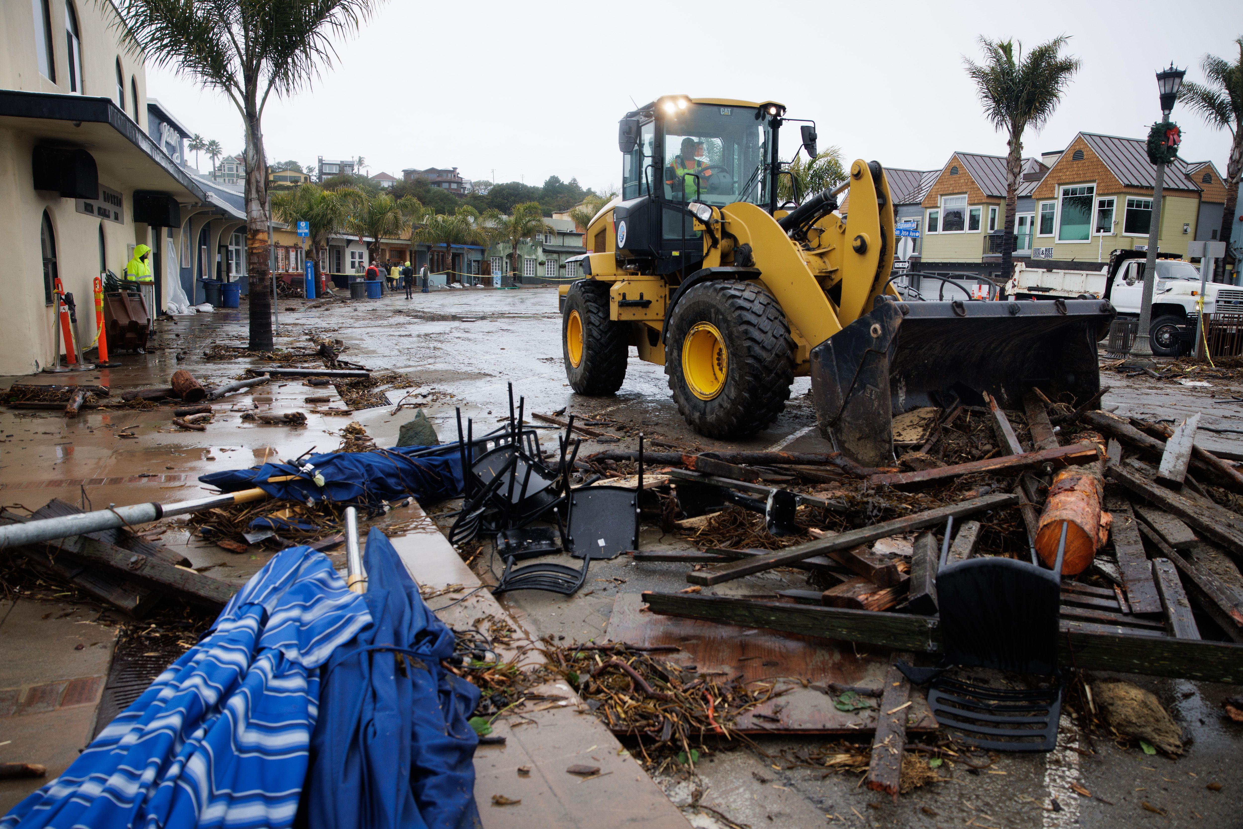 A bulldozerclearing debris from the street at Capitola Village after waves pushed debris down the street damaging bars and restaurants along Esplanade in Capitola, Calif., on Thursday, Jan. 5.
