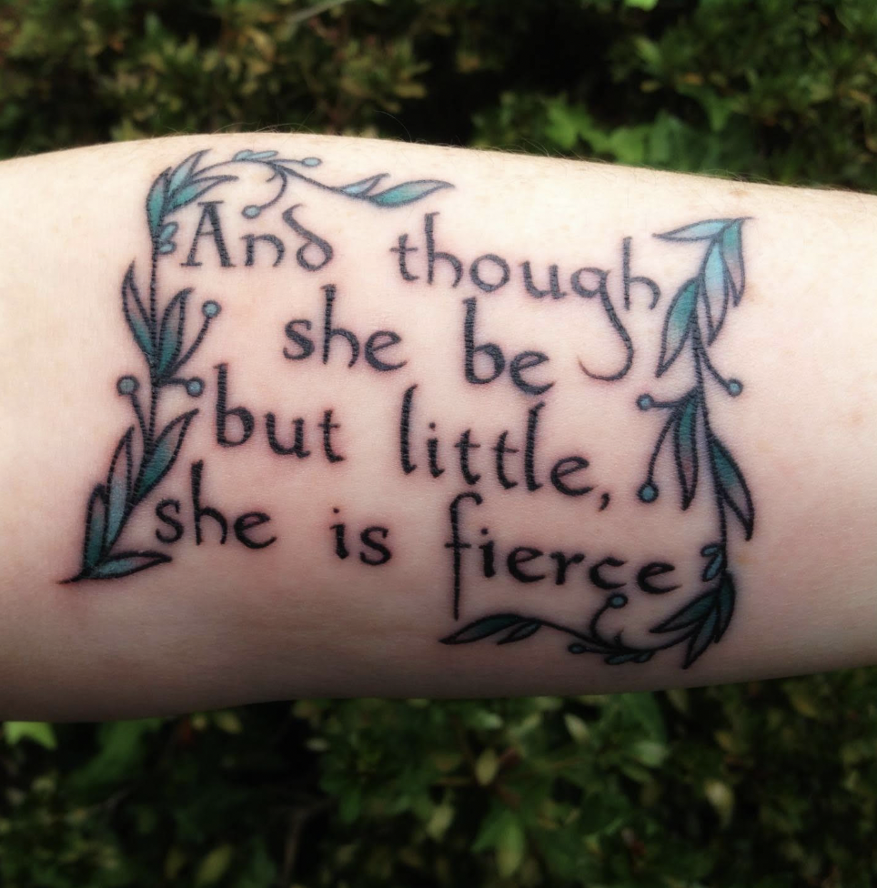 A tattoo of a Shakespeare quote with vines around it