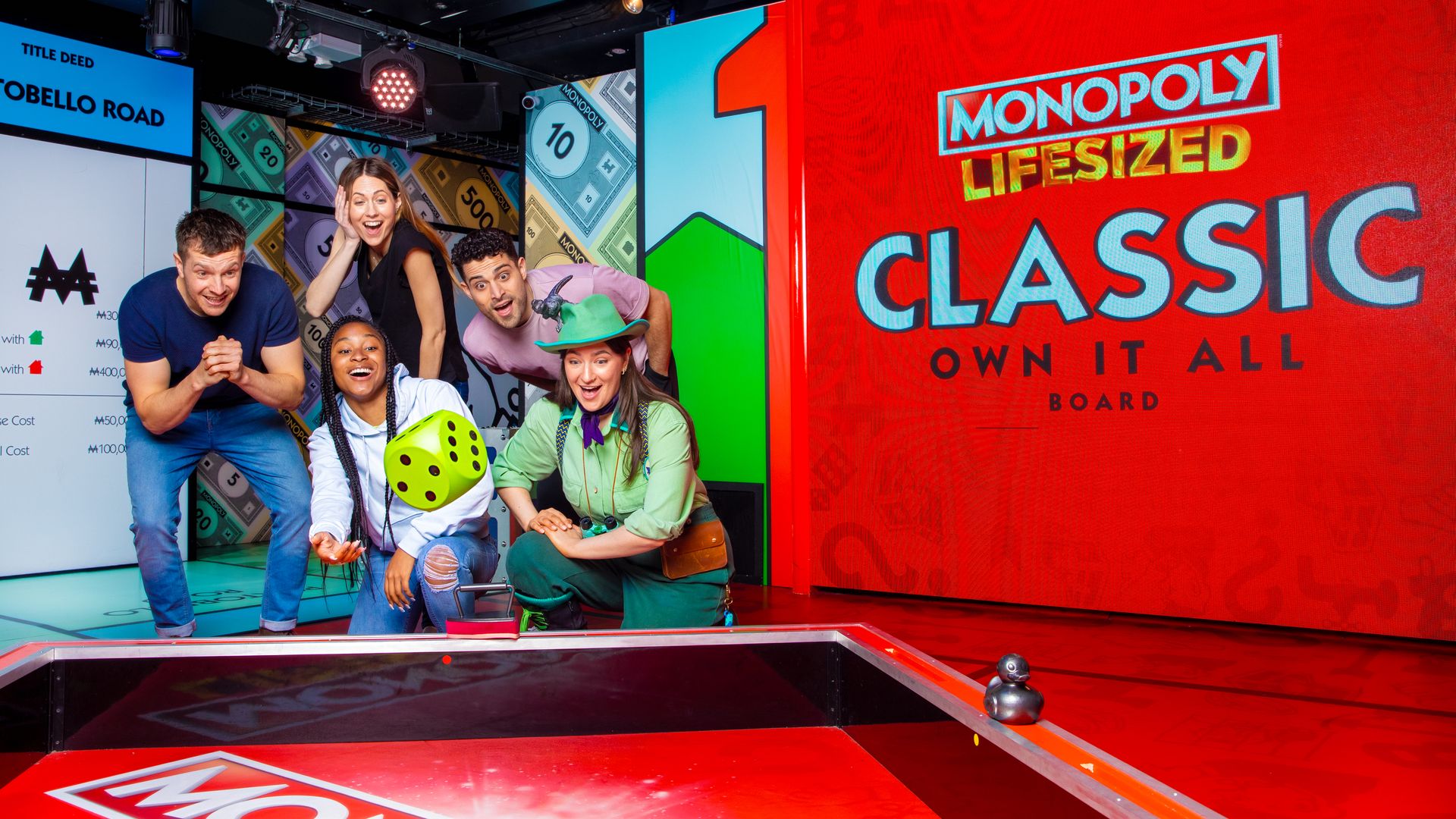 People roll a dice at Monopoly Lifesized