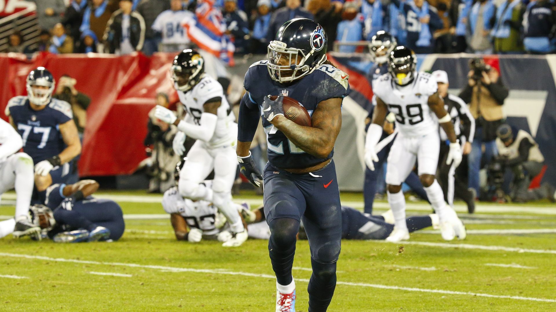 Derrick Henry #22 of the Tennessee Titans runs downfield with the ball for a 99 yard touchdown against the Jacksonville Jaguars at Nissan Stadium on December 6, 2018.