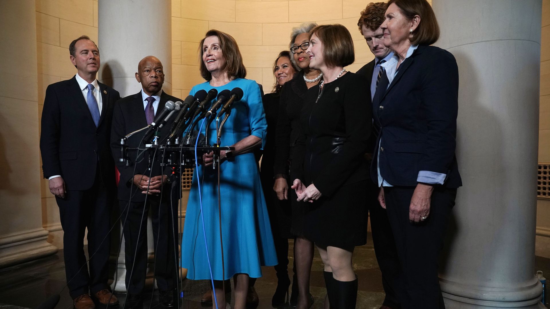 Nancy Pelosi stands with other Democrats at a press conference.