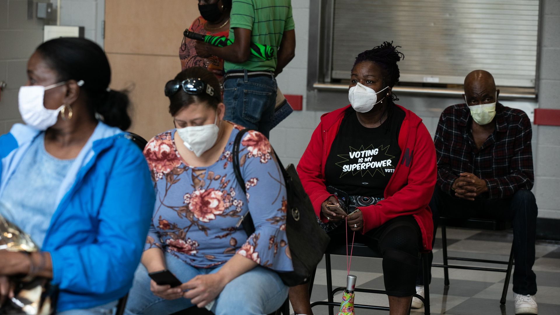 Woman wears a t-shirt that reads, "Voting is my superpower."