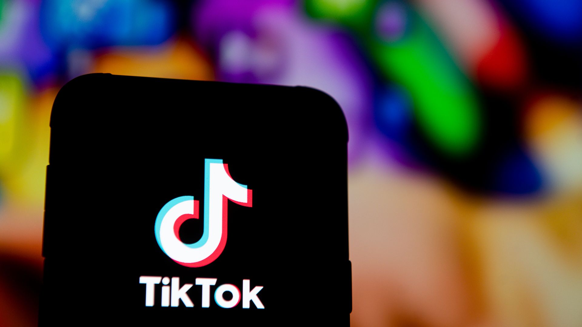 A photo illustration of a TikTok logo displayed on a smartphone.