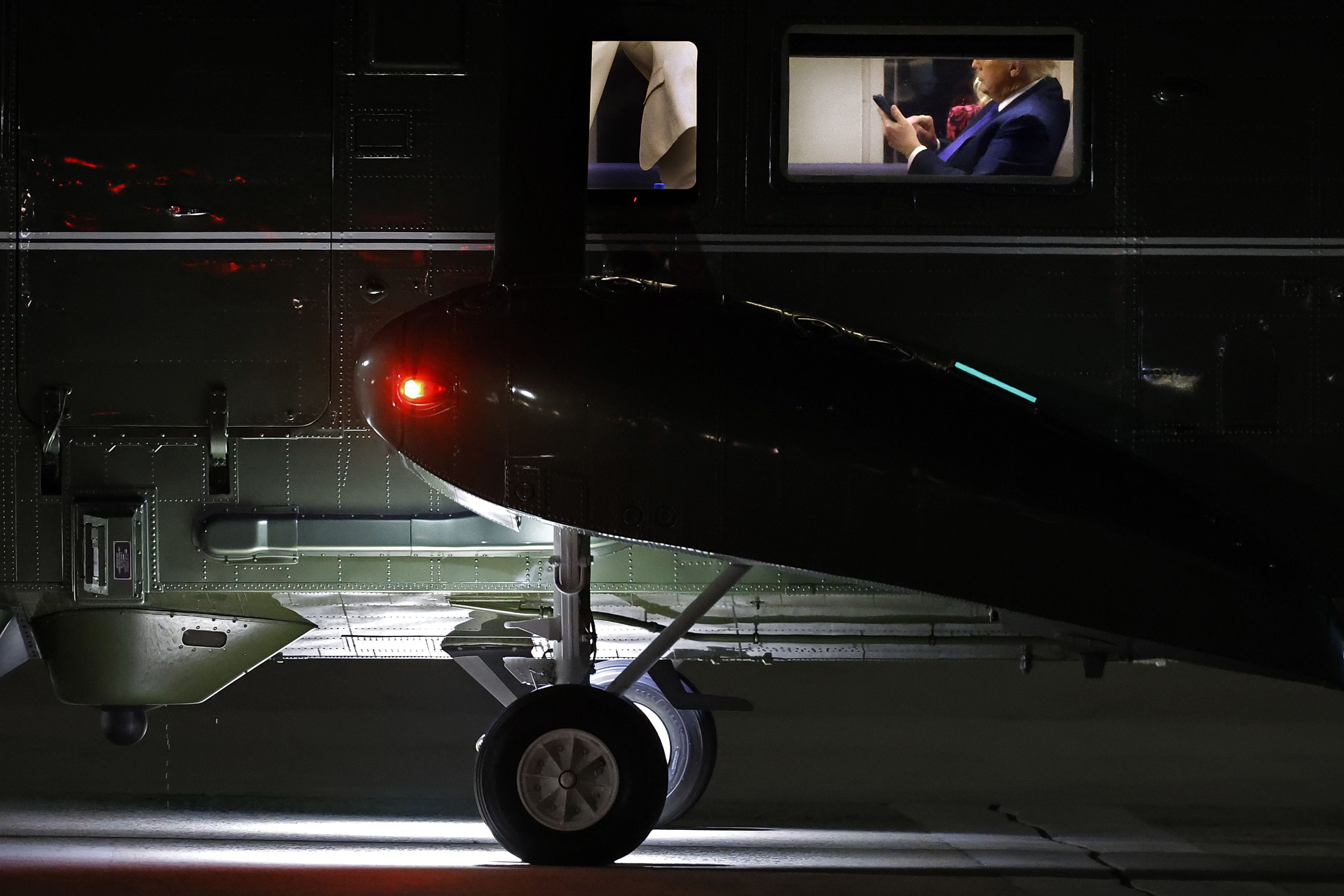 President Trump types on his phone on board Marine One before returning to the White House after addressing the UN General Assembly on Tuesday.