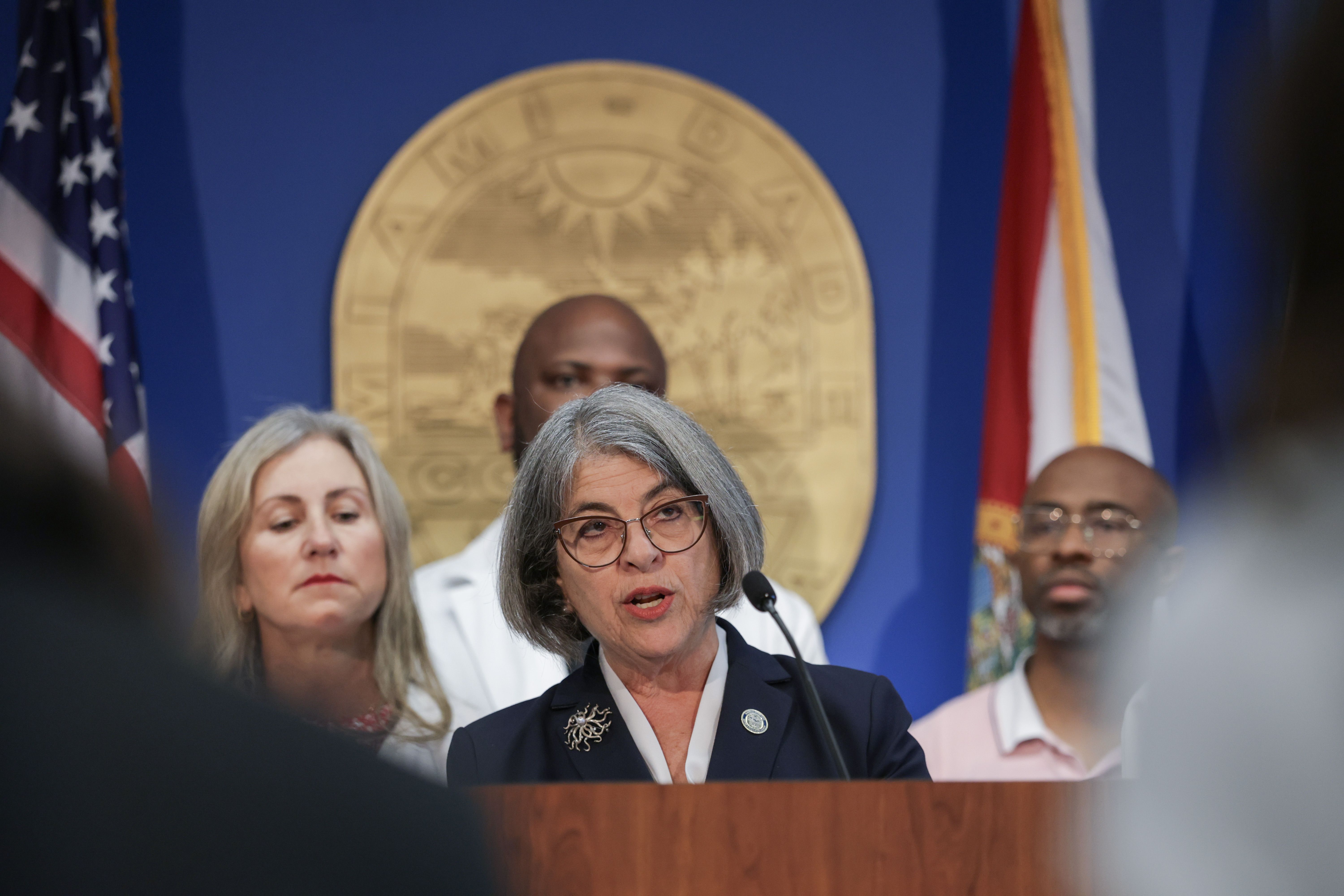 MIAMI, FLORIDA - APRIL 11: Miami-Dade Mayor Daniella Levine Cava, standing with medical experts and dentists, speaks during a press conference addressing the proposed removal of fluoride from the county's drinking water on April 11, 2025 in Miami, Florida. Mayor Levine Cava said she vetoed a resolut