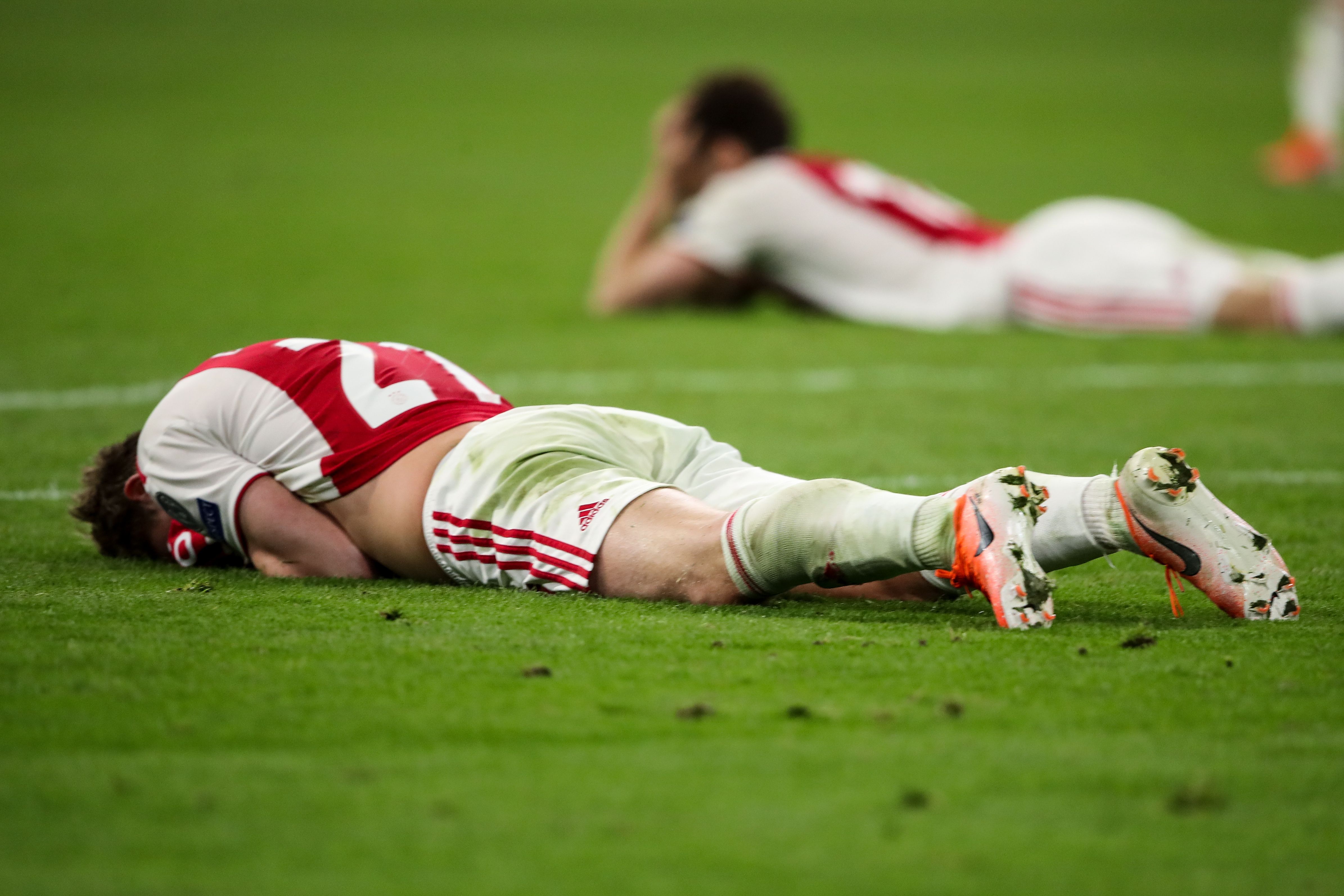 Ajax players lying on the pitch