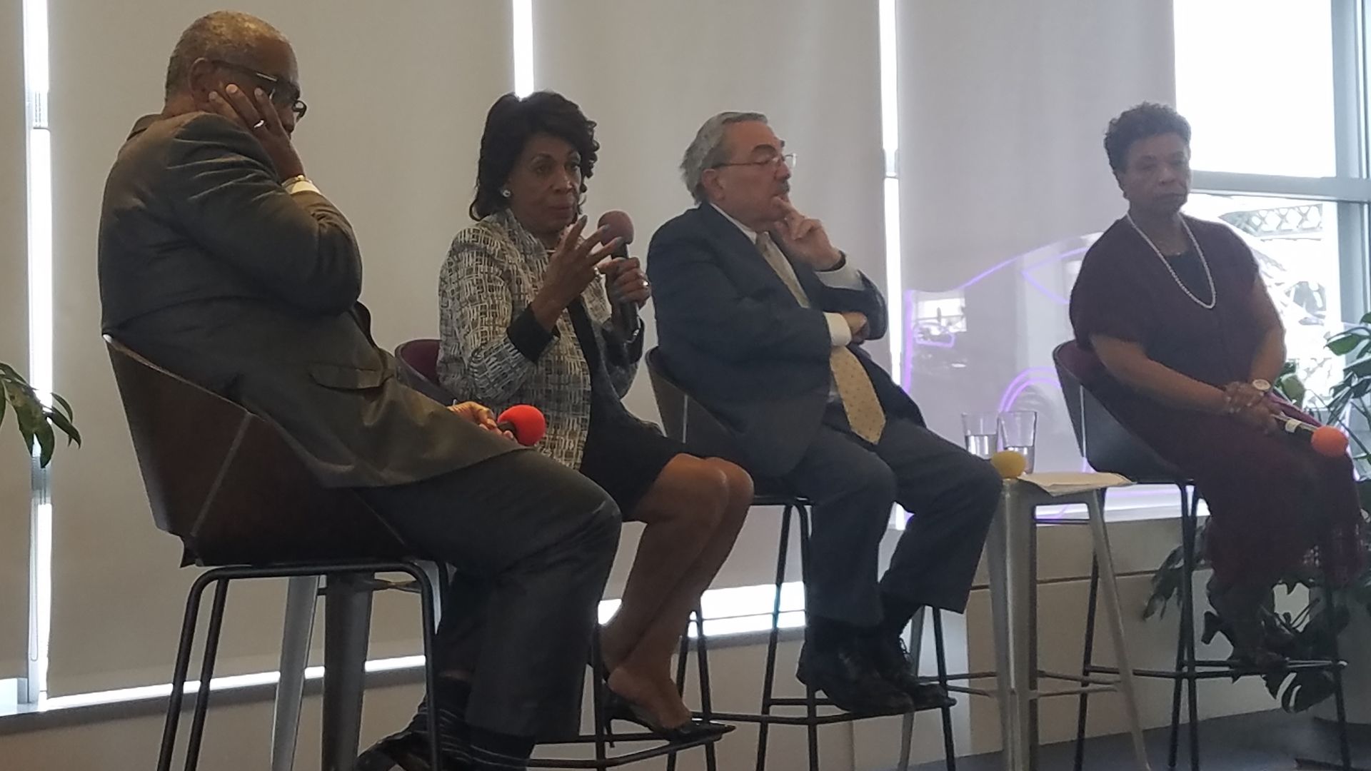 Reps. Meeks, Waters, Butterfield, and Lee seated on stage