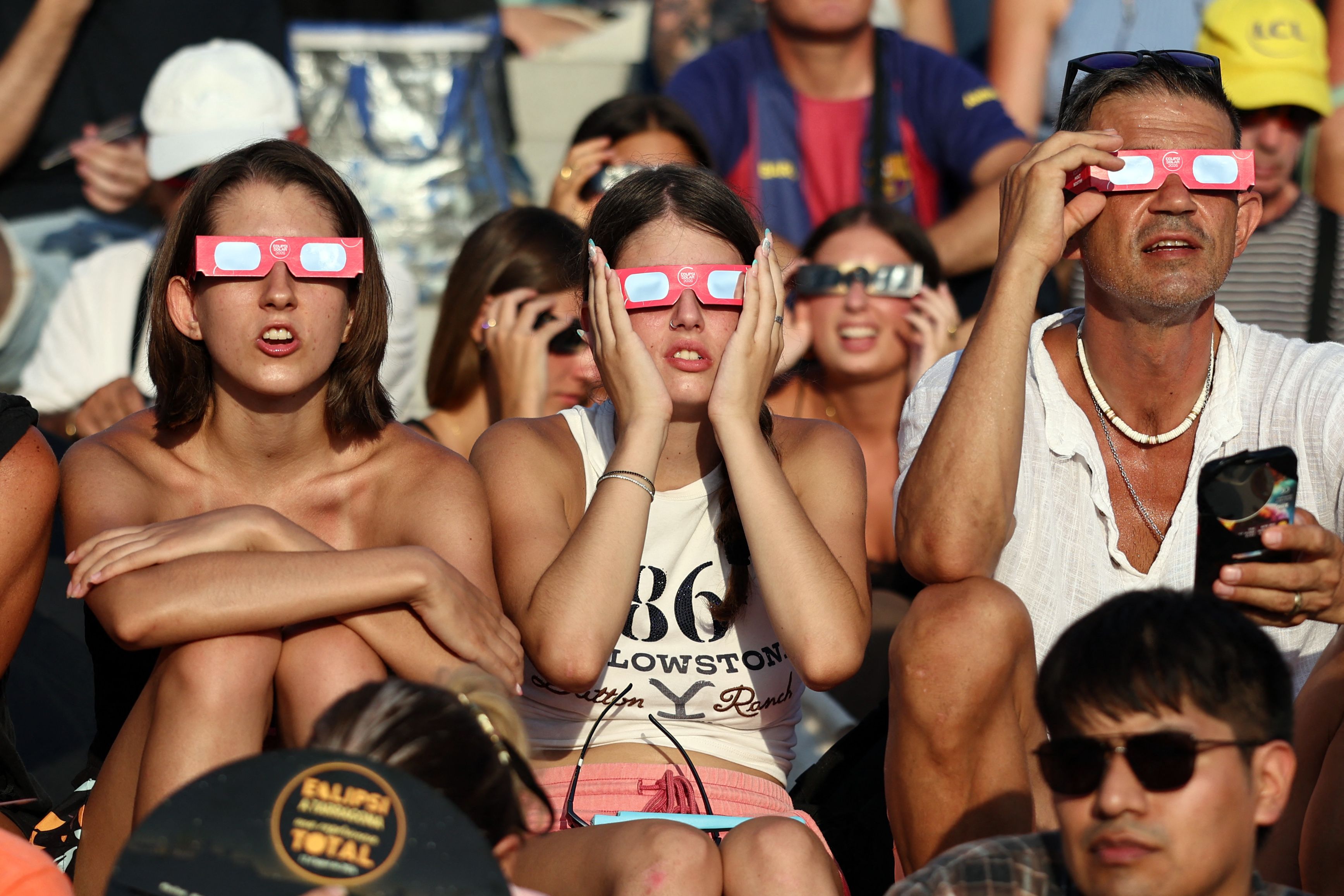 People watch today's total solar eclipse in Tarragona, east of Spain. Photo: Josep Lago/AFP via Getty Images.