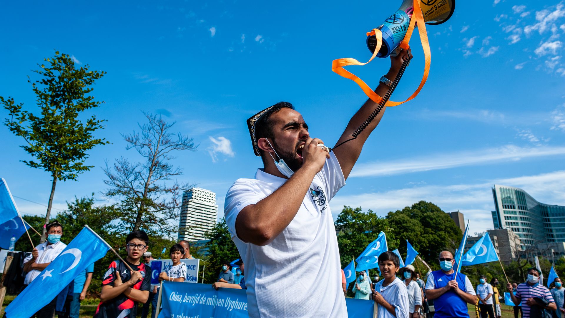 Picture of an Uyghur man shouting into a megaphone during a demonstration in the Netherlands