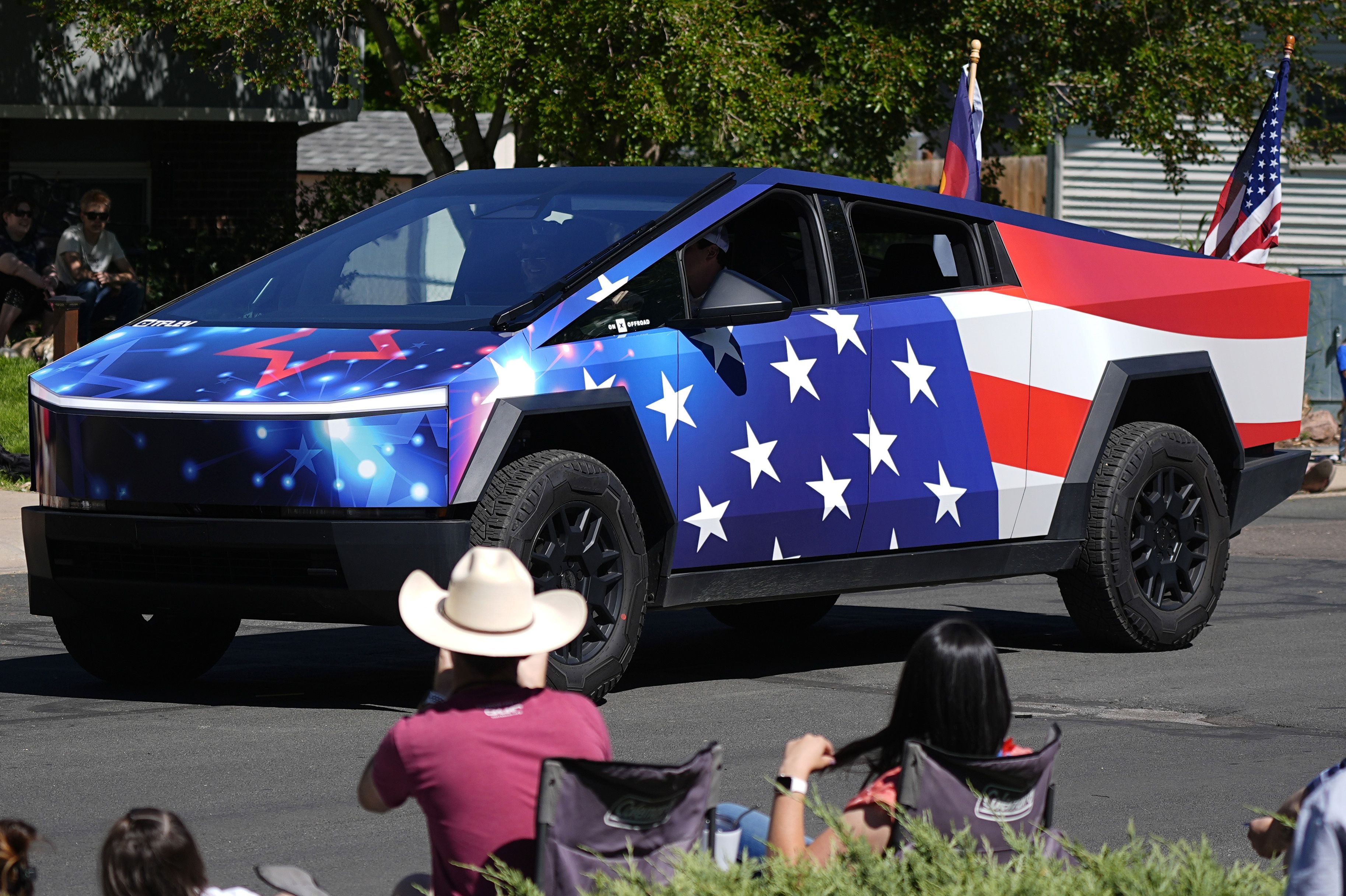 A Tesla Cybertruck wrapped in a patriotic motif takes part in the Colorado 4th at Firestone parade to mark the Independence Day holiday Thursday, July 4, 2024, in Firestone, Colo. Floats, marching bands, classic cars and motorcycles were features in the annual parade through the Weld County communit