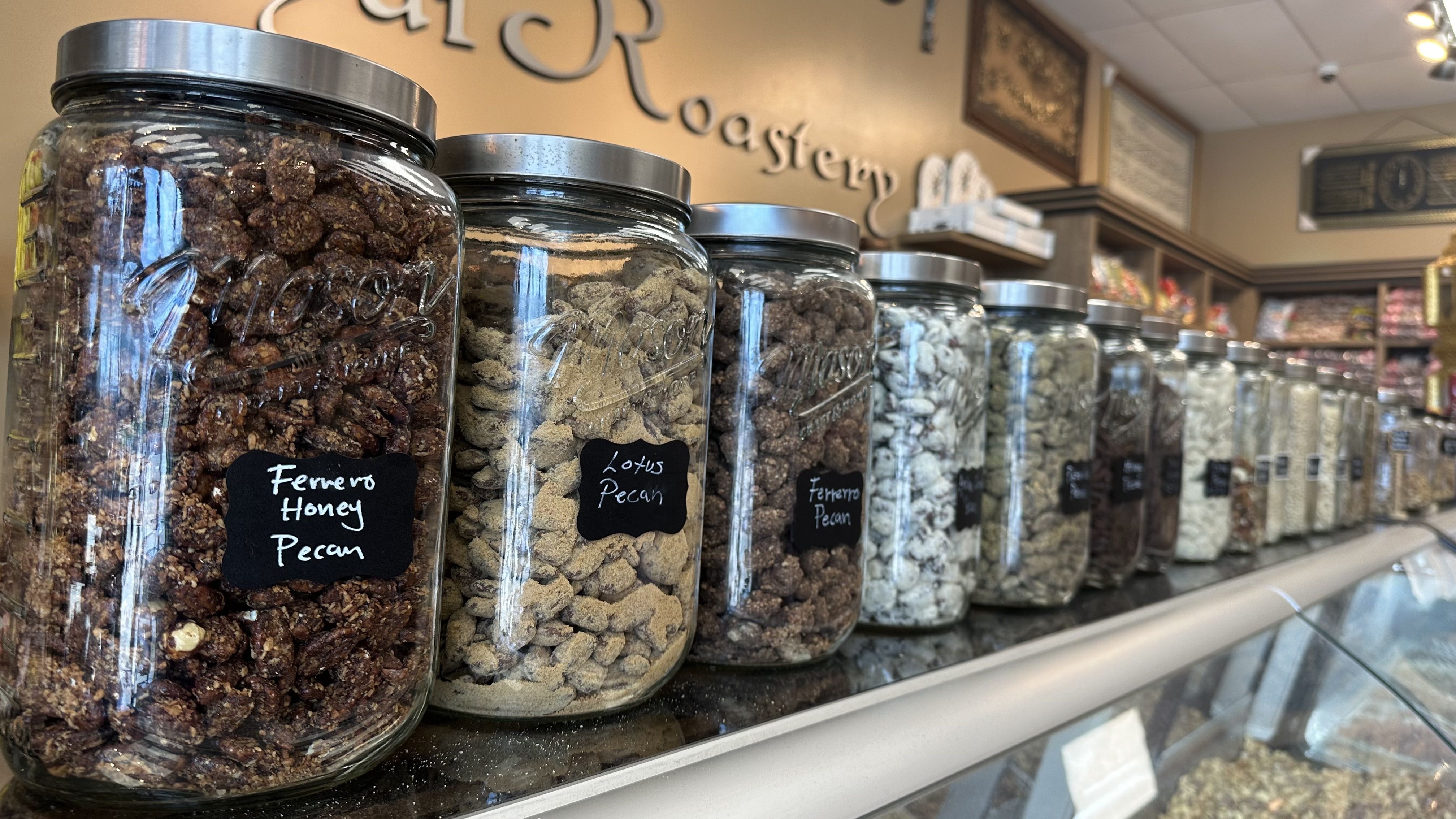 A close-up picture of jars of roasted and flavored nuts.