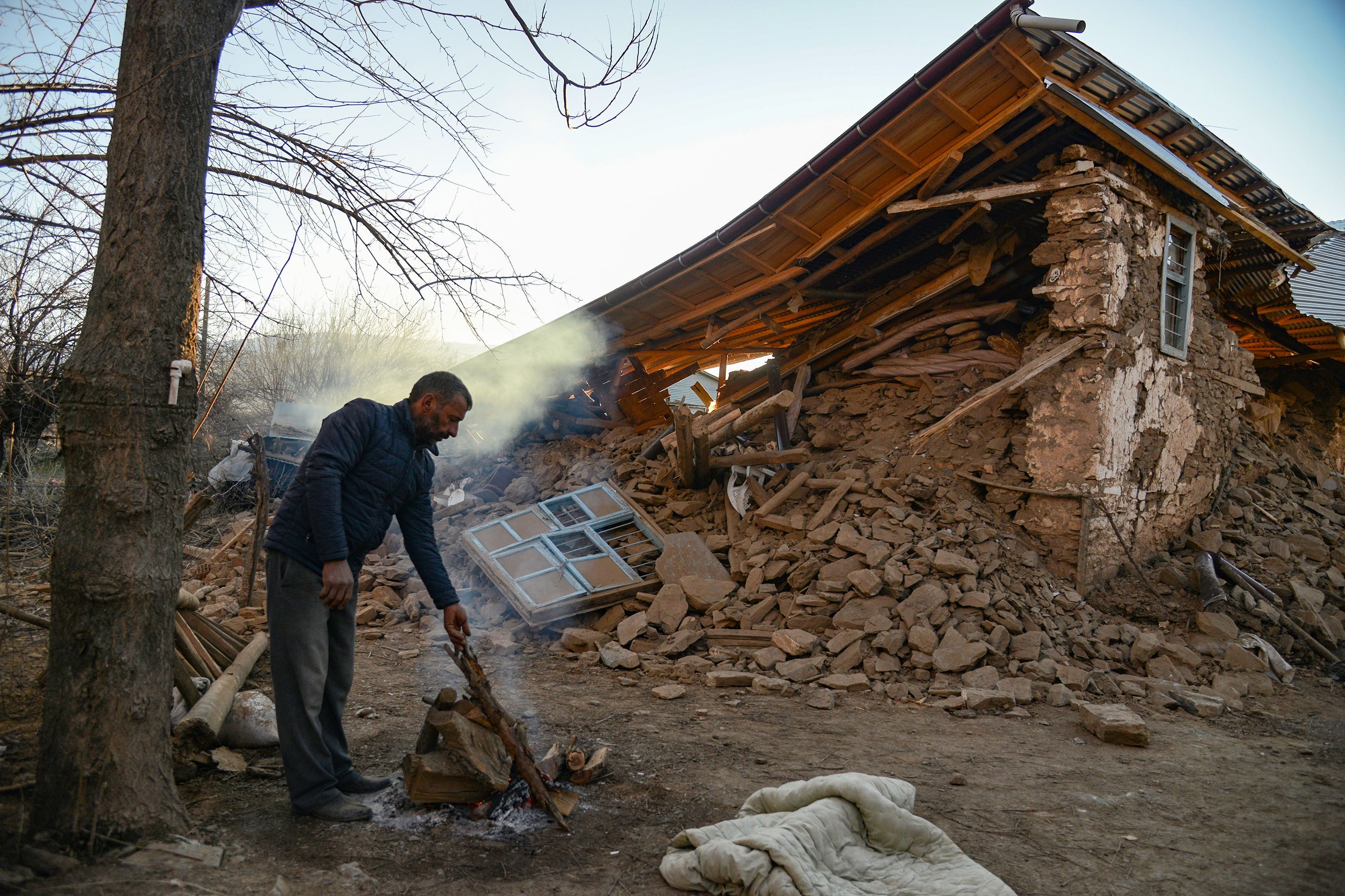 A villager stands by his collapsed house after an earthquake in Sivrice near Elazig, Eastern Turkey, 