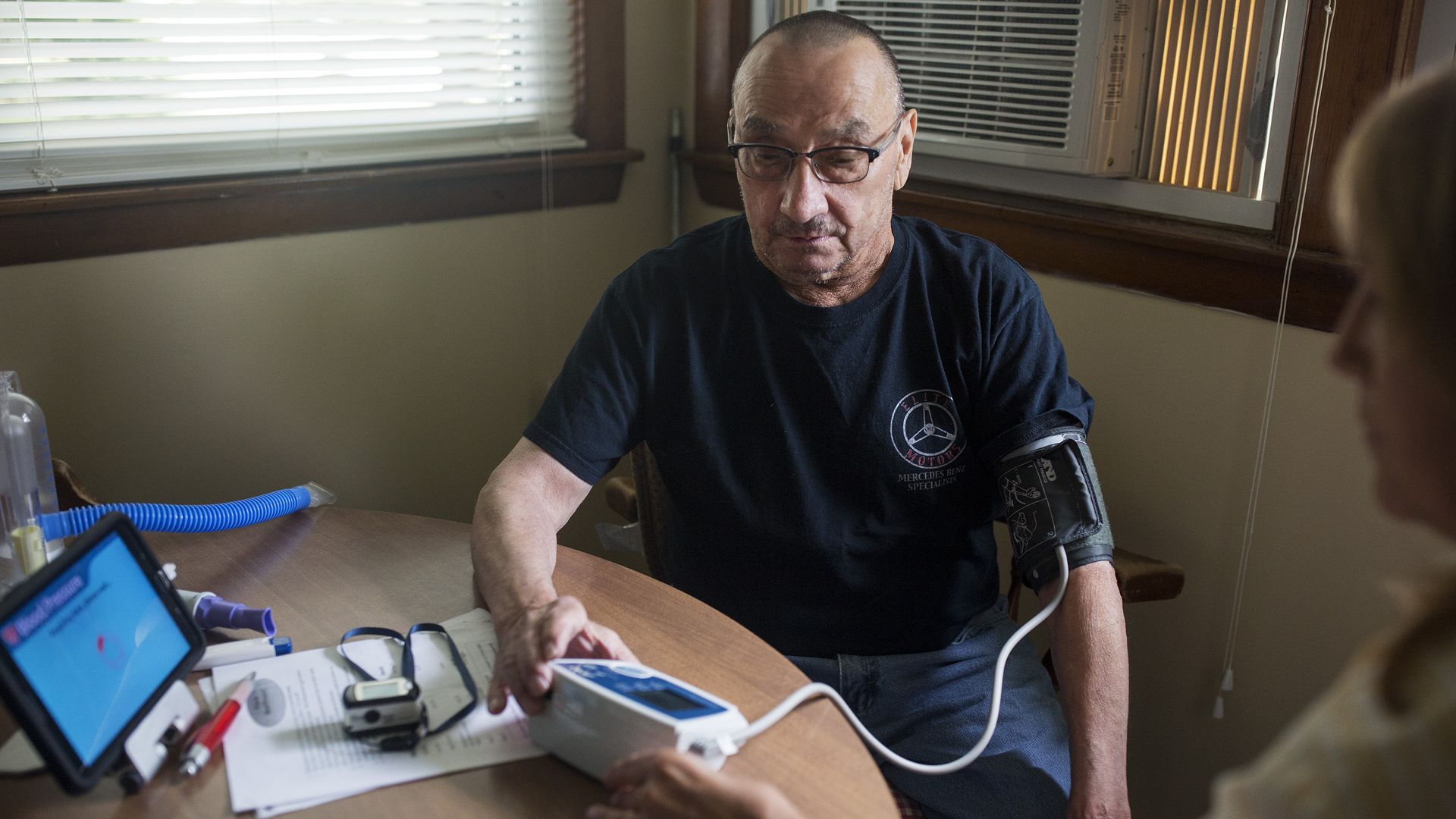 A man measures his vitals and sends the data electronically to nurses.